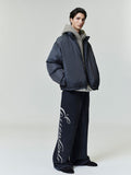 Full side view of model wearing oversized dark ripstop nylon puffer jacket with high collar, file 0001_HO25_F_L81_P41_4406.jpg