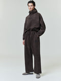 Model wearing dark brown Suede Fleece Flare Pant with drawstring waist and relaxed fit, front view on neutral background