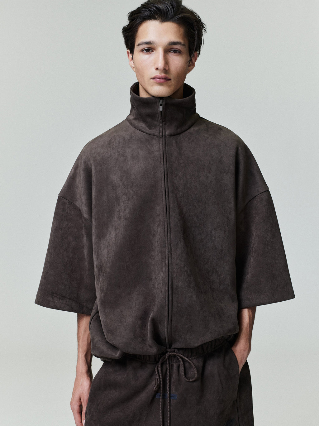 Front view of model wearing dark brown suede fleece high neck jacket with oversized fit and 3/4 sleeves, file 0025_HO25_F_L15_1864_OnModelImage.jpg