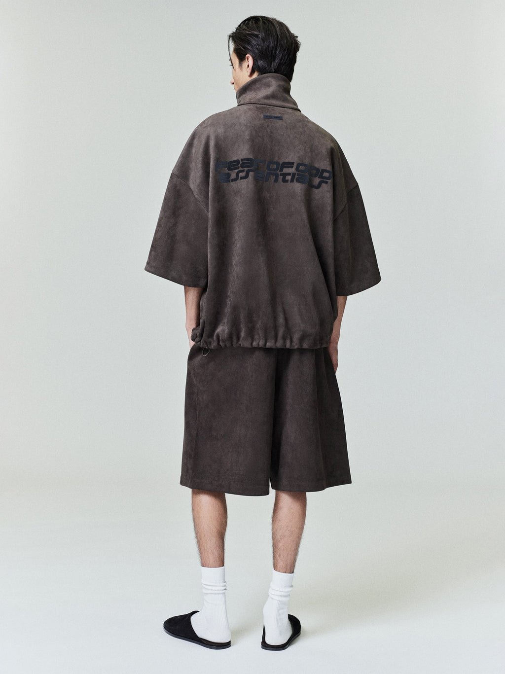 Rear view of model wearing suede fleece high neck jacket with 3/4 sleeves and matching shorts, file 0027_HO25_F_L15_1786_OnModelImage.jpg