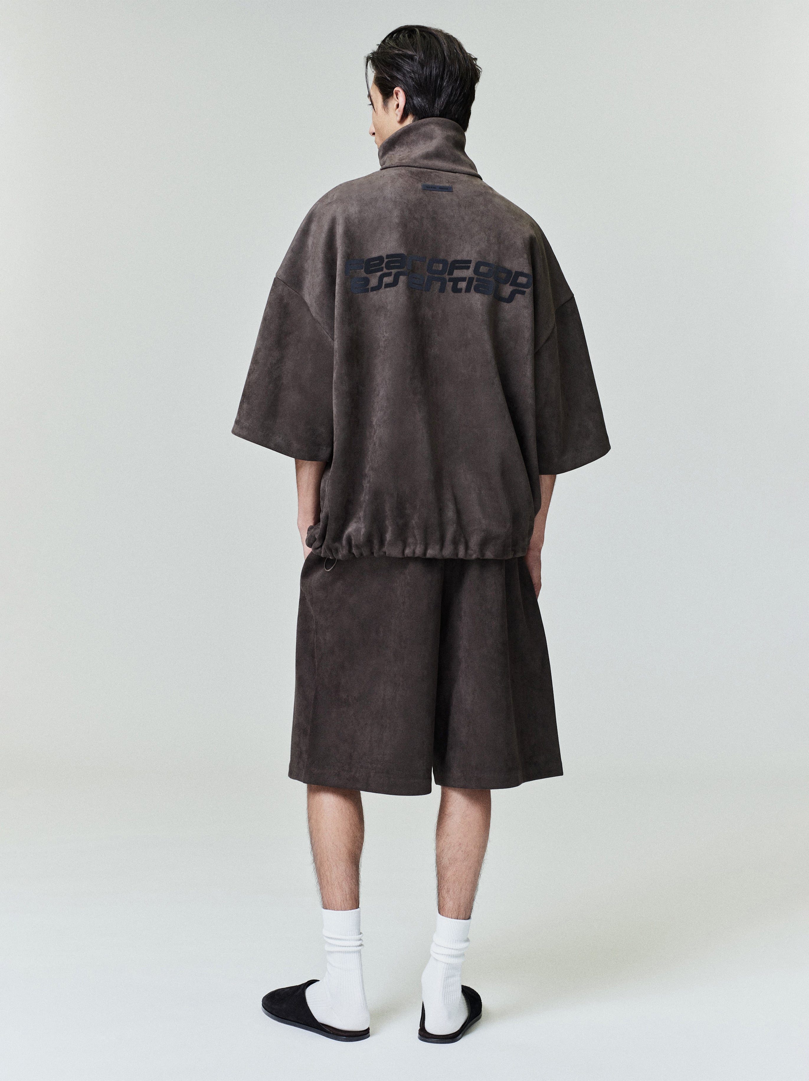 Rear view of model wearing suede fleece high neck jacket with 3/4 sleeves and matching shorts, file 0027_HO25_F_L15_1786_OnModelImage.jpg