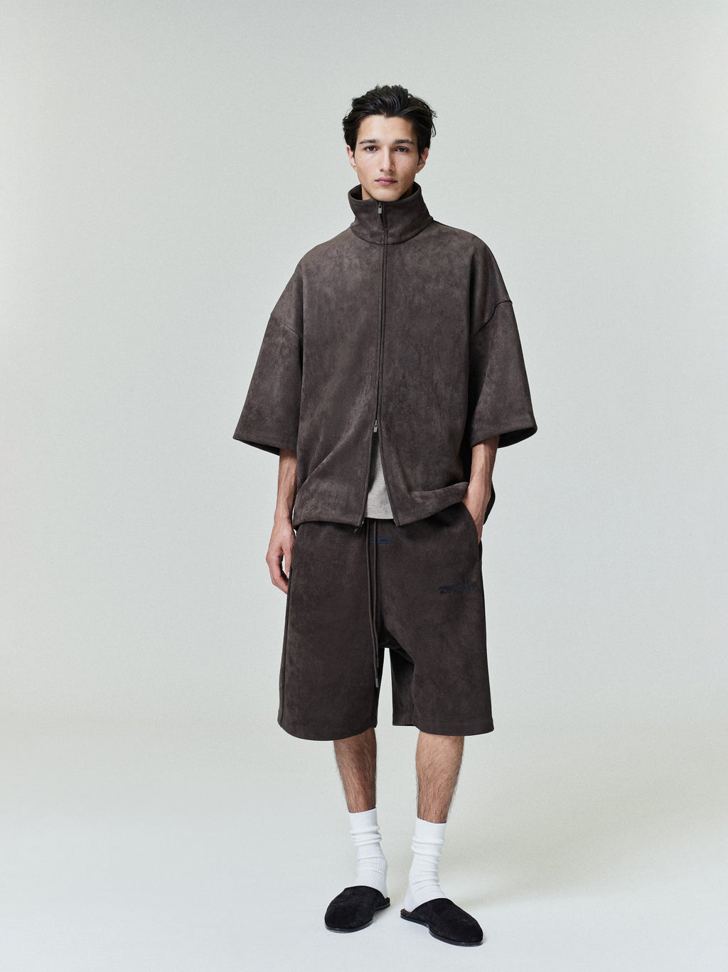 Front view of model wearing suede fleece high neck jacket with 3/4 sleeves and matching shorts, file 0028_HO25_F_L15_1728_OnModelImage.jpg