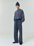 Full-length image of model wearing navy Chicago heavy fleece cropped sweatshirt with red sleeve lettering 0039_HO25_F_L07_P13_0738.jpg
