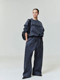 Model wearing dark charcoal Suede Fleece Modern Crewneck Sweatshirt with matching wide-leg pants in gallery shot 0043_HO25_FW_L37_0412.jpg