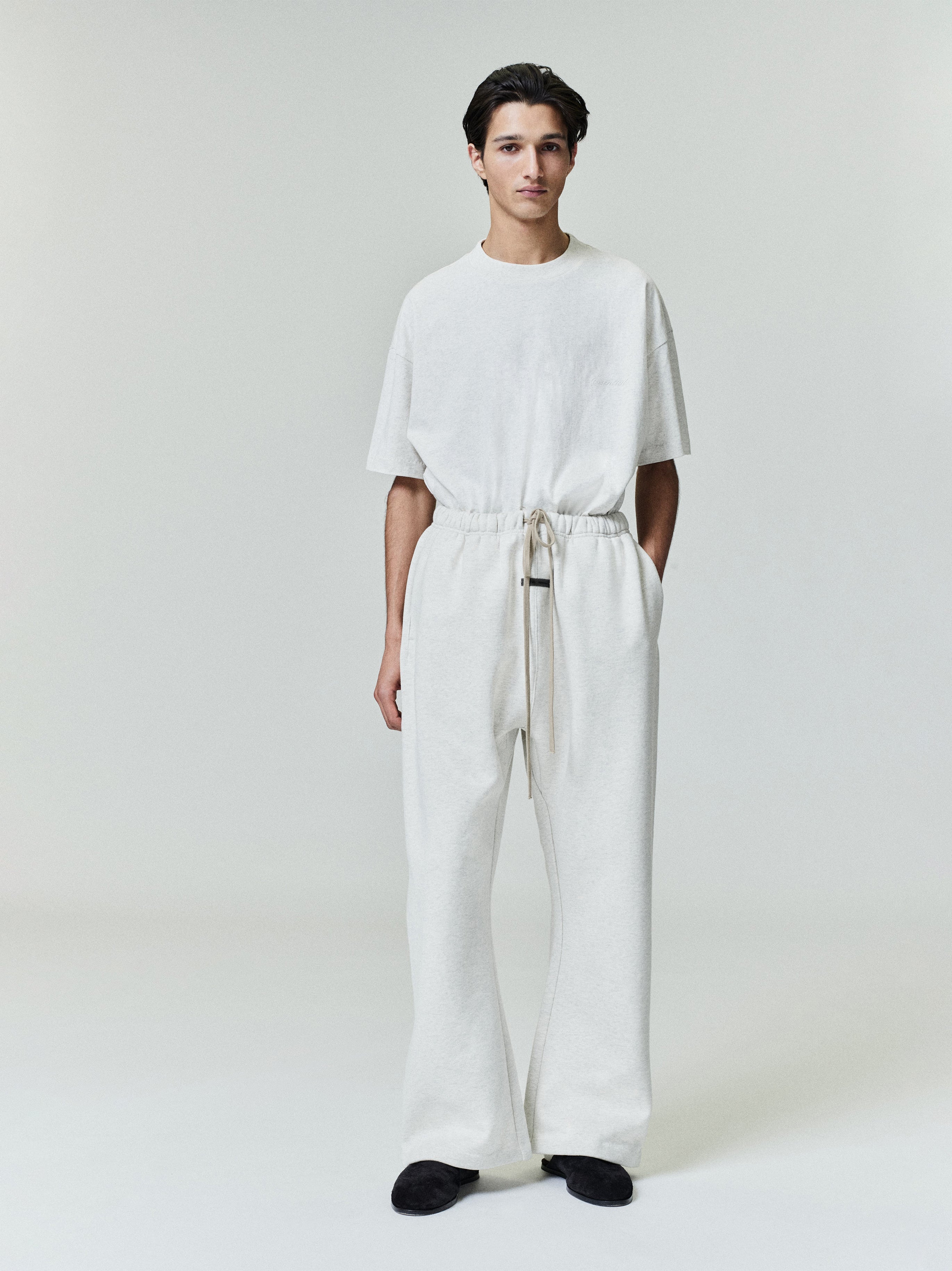 Male model wearing cream Flare Sweatpant with elastic waistband and long drawstrings, front view, gallery image 0