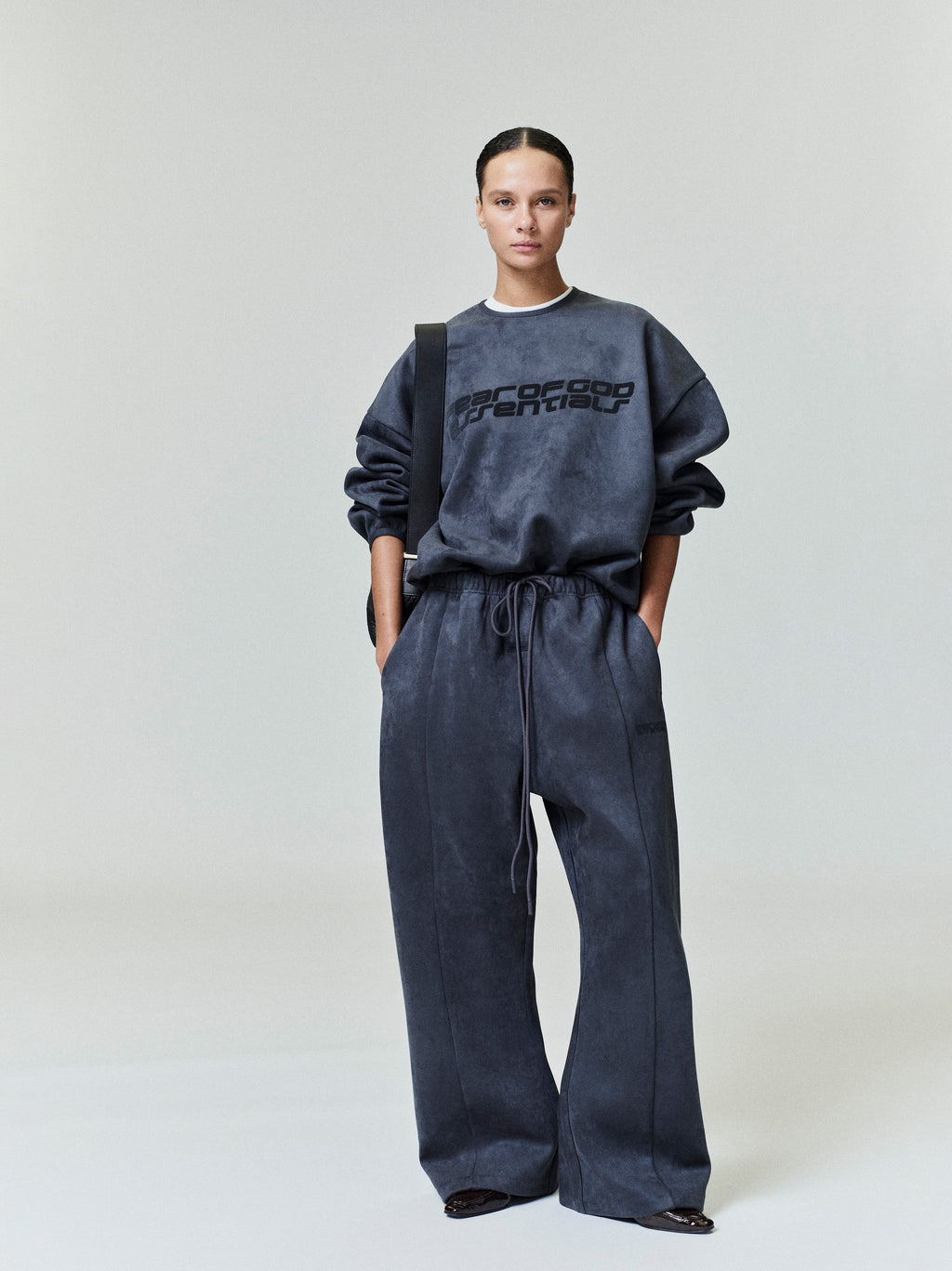 Model wearing dark charcoal Suede Fleece Modern Crewneck Sweatshirt and matching wide-leg pants, studio shot 0045_HO25_FW_L37_0405.jpg