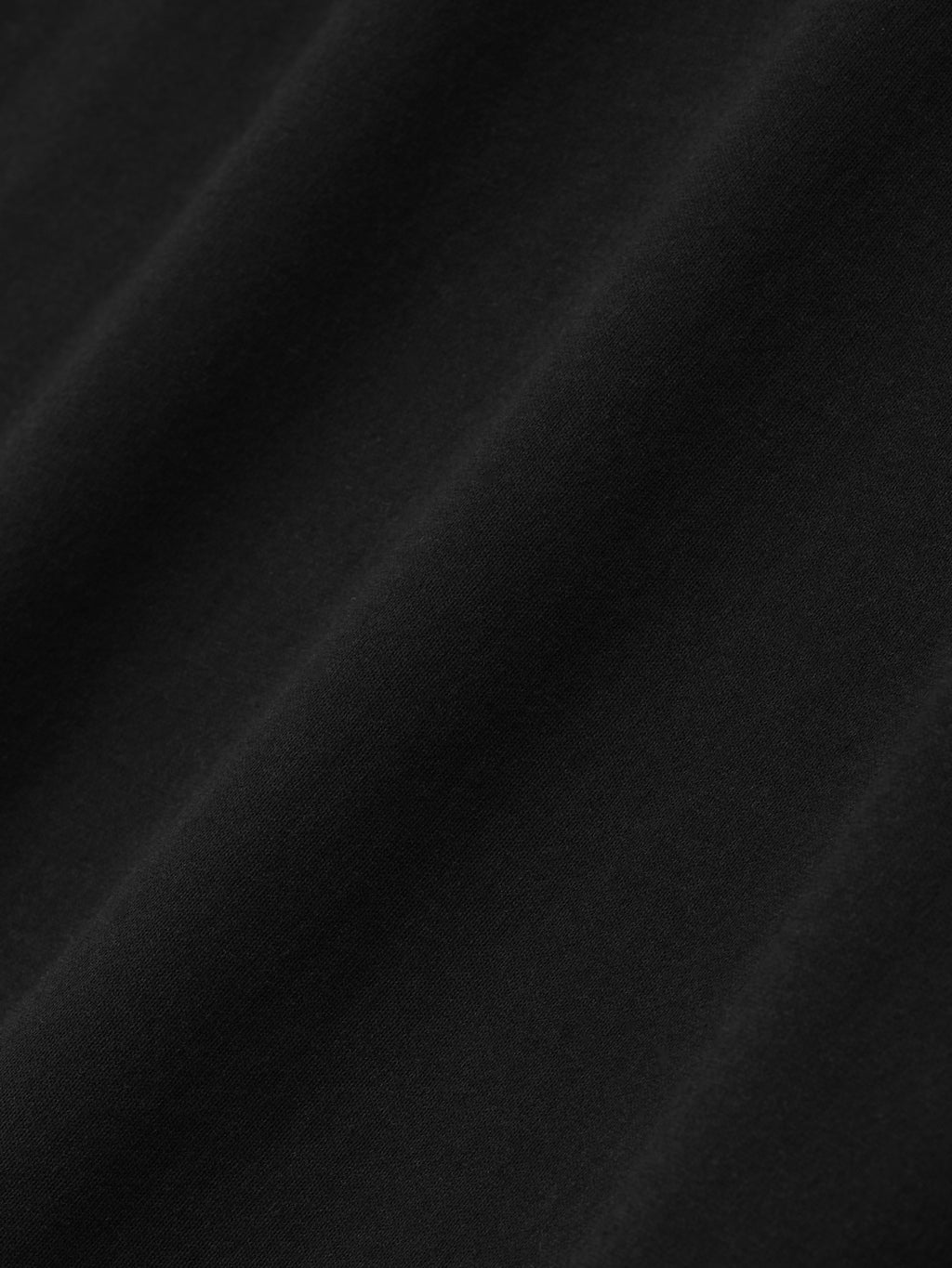Close-up of smooth black fabric texture on Berlin 90s Fit Tee, file 125EU264201F, gallery image 0