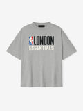 Front view of concrete heather London 90s Fit Tee with bold black LONDON and cream ESSENTIALS text, gallery image 0