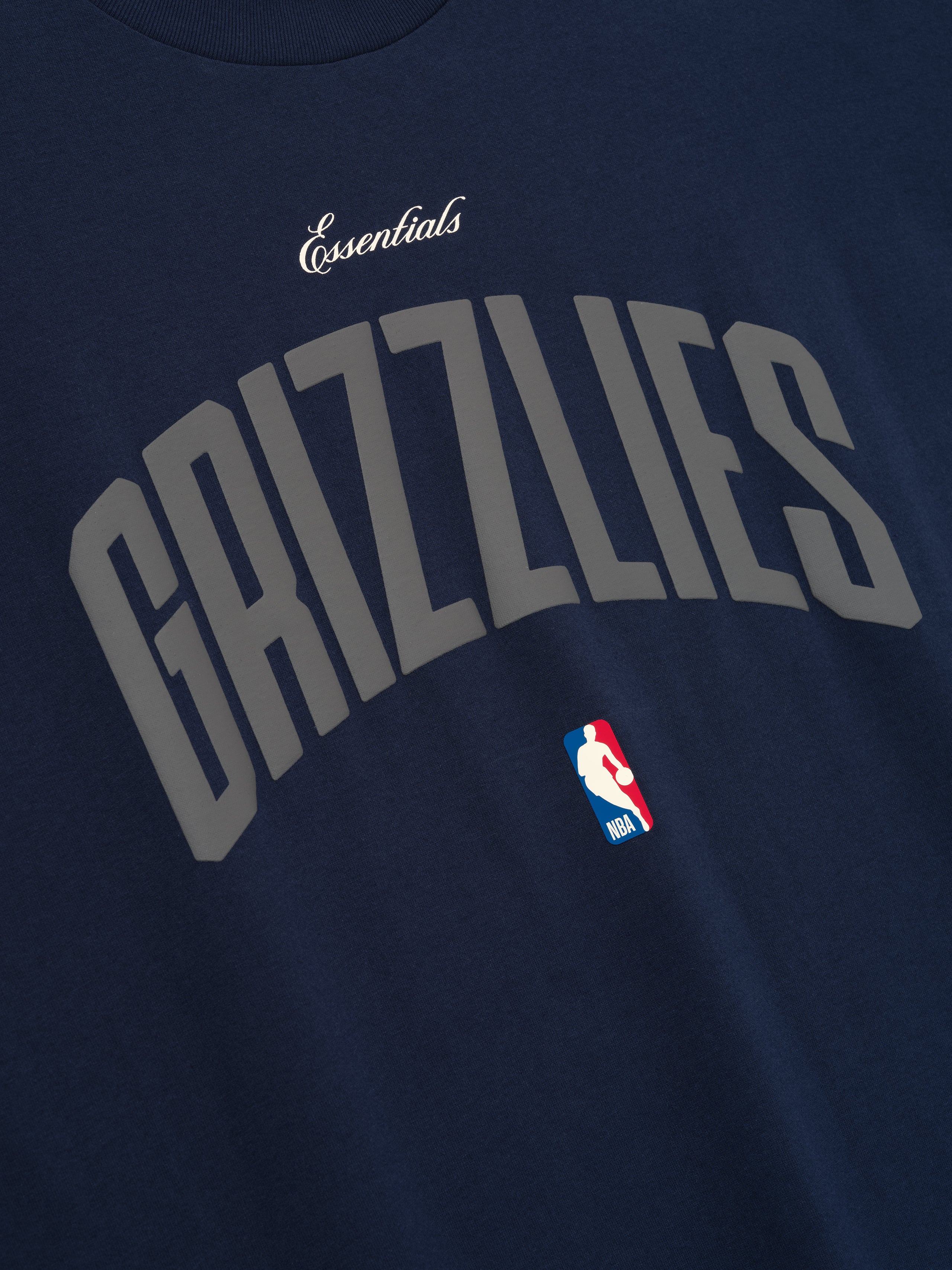 Close-up of midnight navy Memphis Grizzlies 90'S Fit Tee featuring curved grey Grizzlies text and NBA logo, gallery image 0.