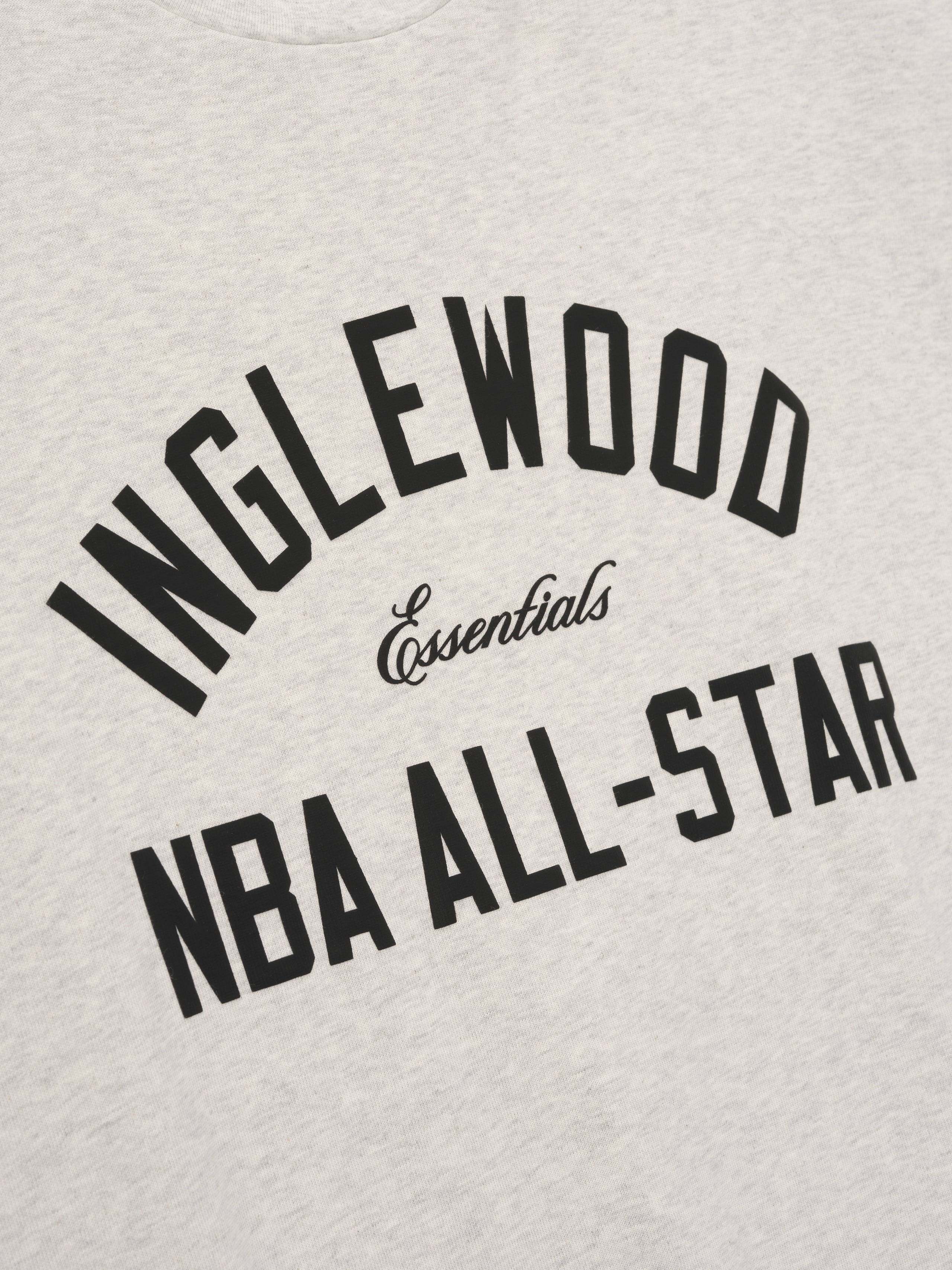 light beige cotton tee with bold Inglewood NBA All-Star arched text and Essentials script center chest design
