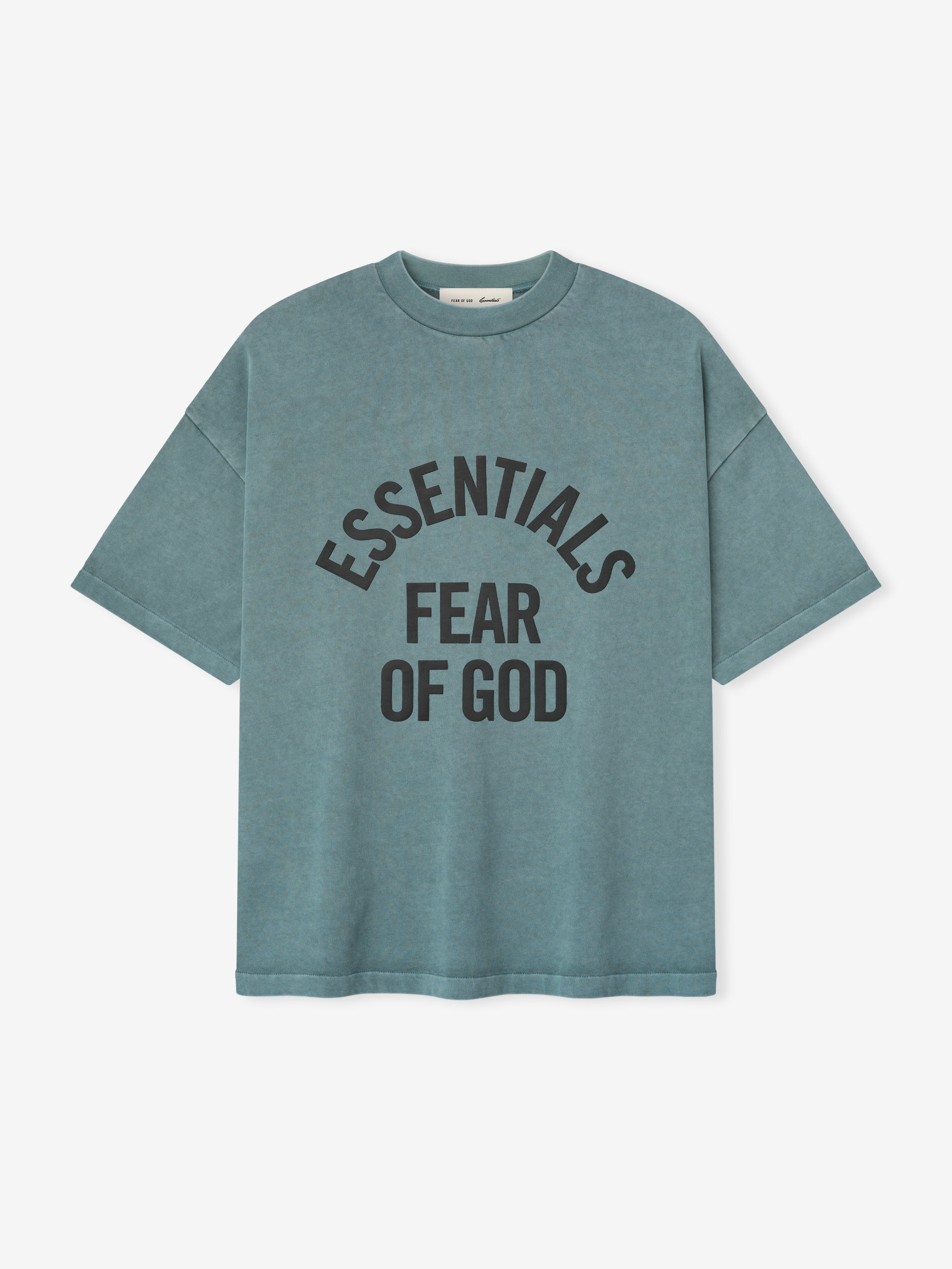 pigment-dyed heavyweight cotton crewneck tee in faded blue with bold "ESSENTIALS FEAR OF GOD" text curved on front