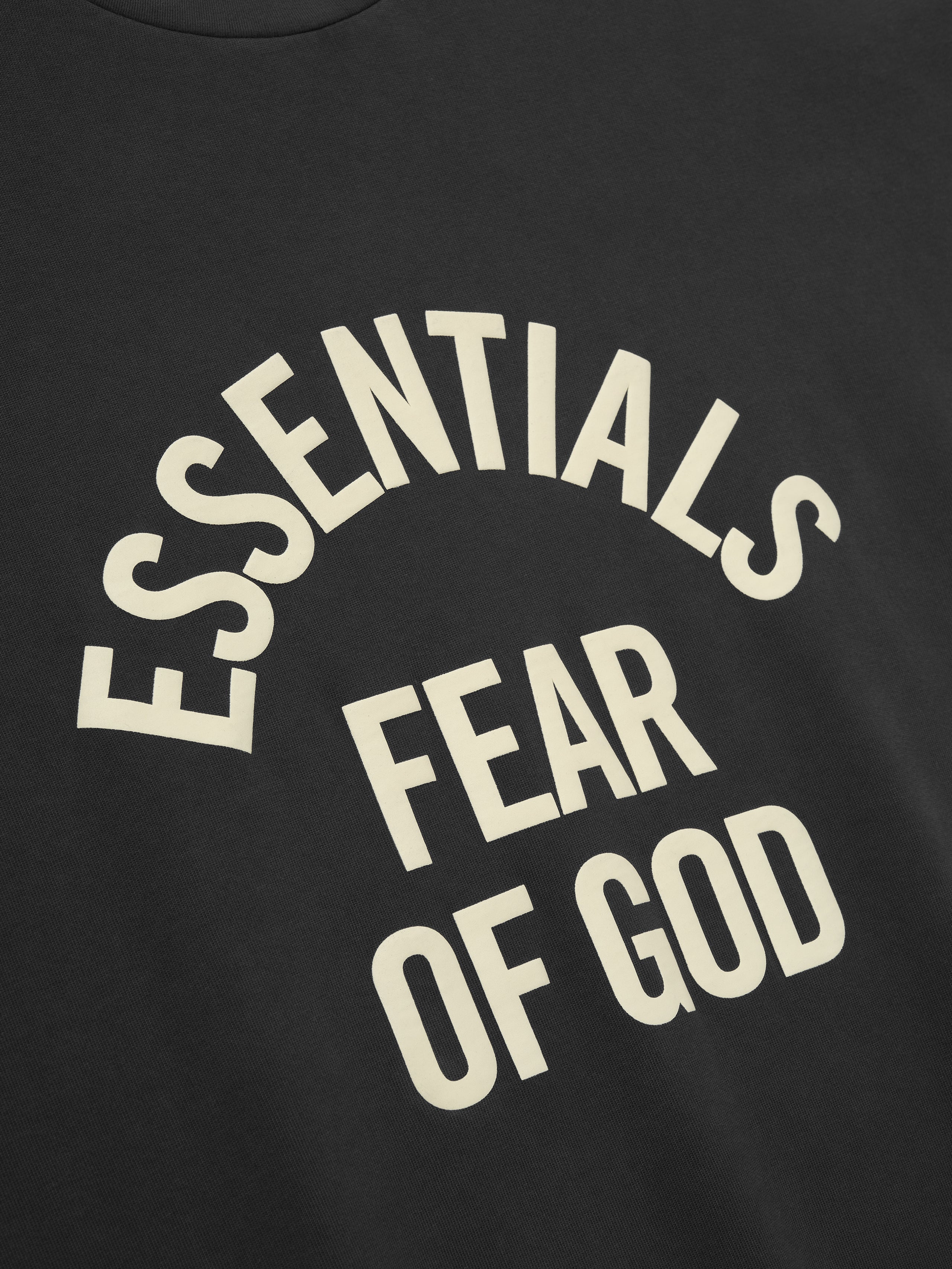 black heavyweight cotton long sleeve tee with vintage pigment dye and curved ESSENTIALS FEAR OF GOD text on front