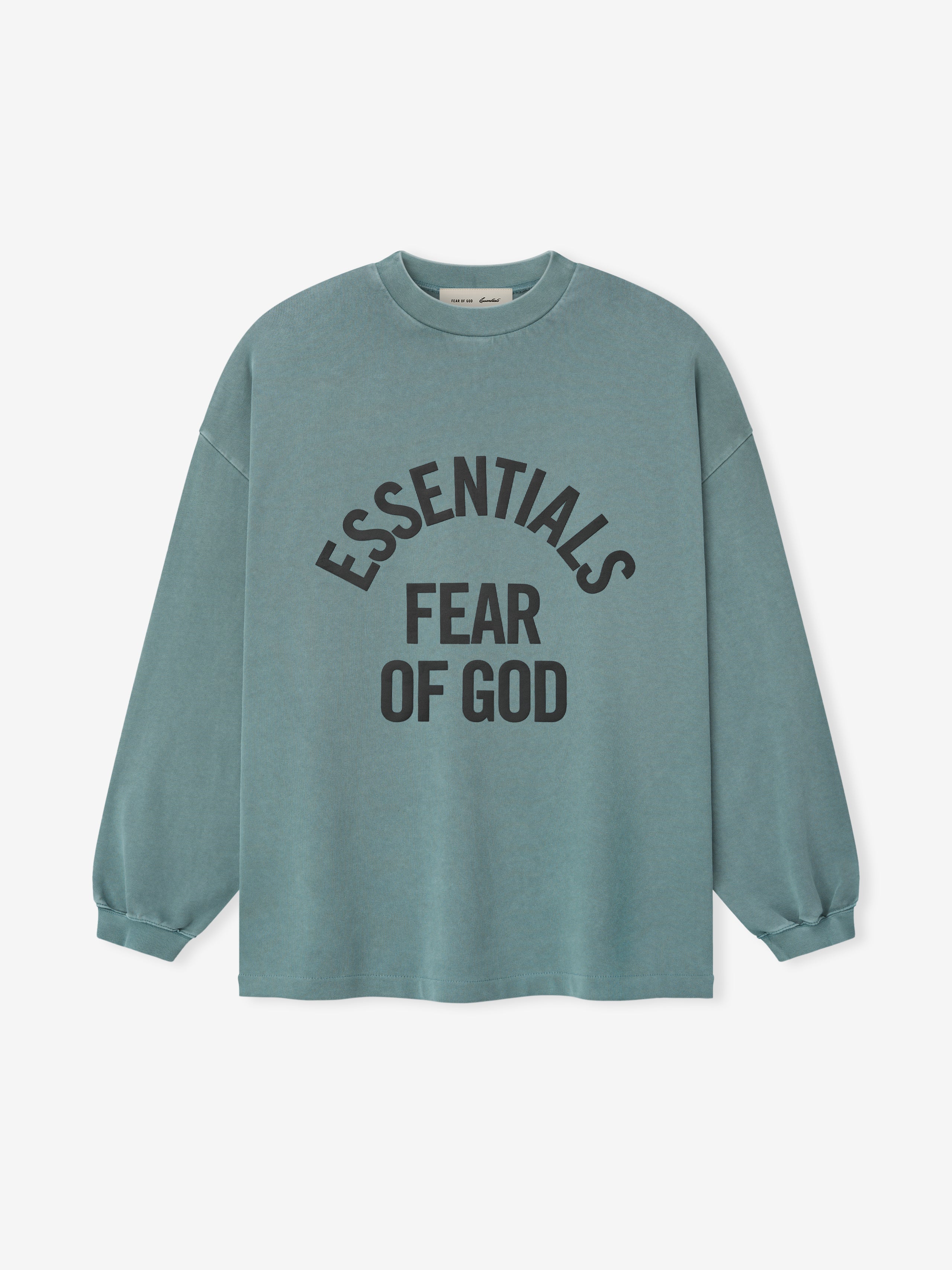 pigment-dyed heavyweight cotton long sleeve tee in muted teal with bold curved ESSENTIALS FEAR OF GOD text front