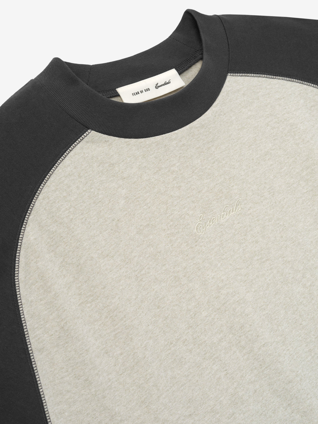 medium-weight cotton jersey baseball tee with oversized fit, rib-knit crewneck, and contrasting dark raglan sleeves