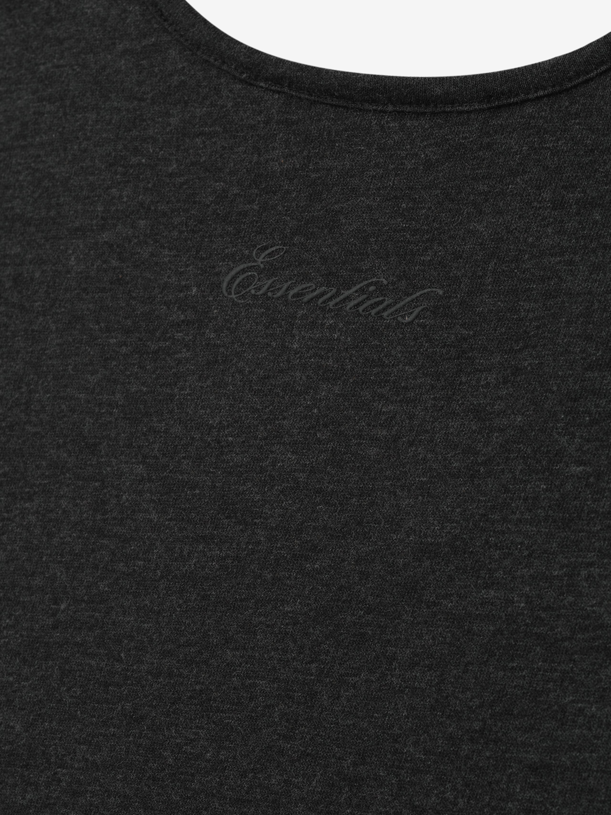 Black tank top with 'Essentials' script logo