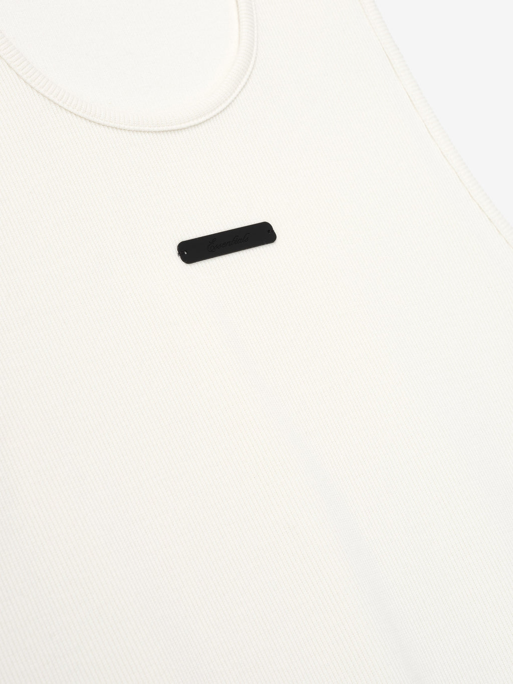 close-up of off-white ribbed cotton spandex tank top with minimalist Essentials signature LA logo on chest