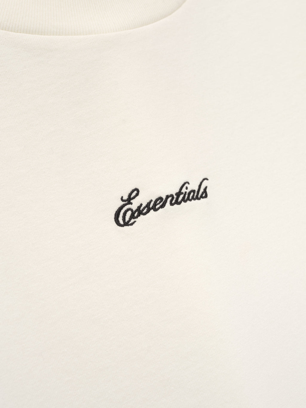 White t-shirt with 'essentials' embroidery. 