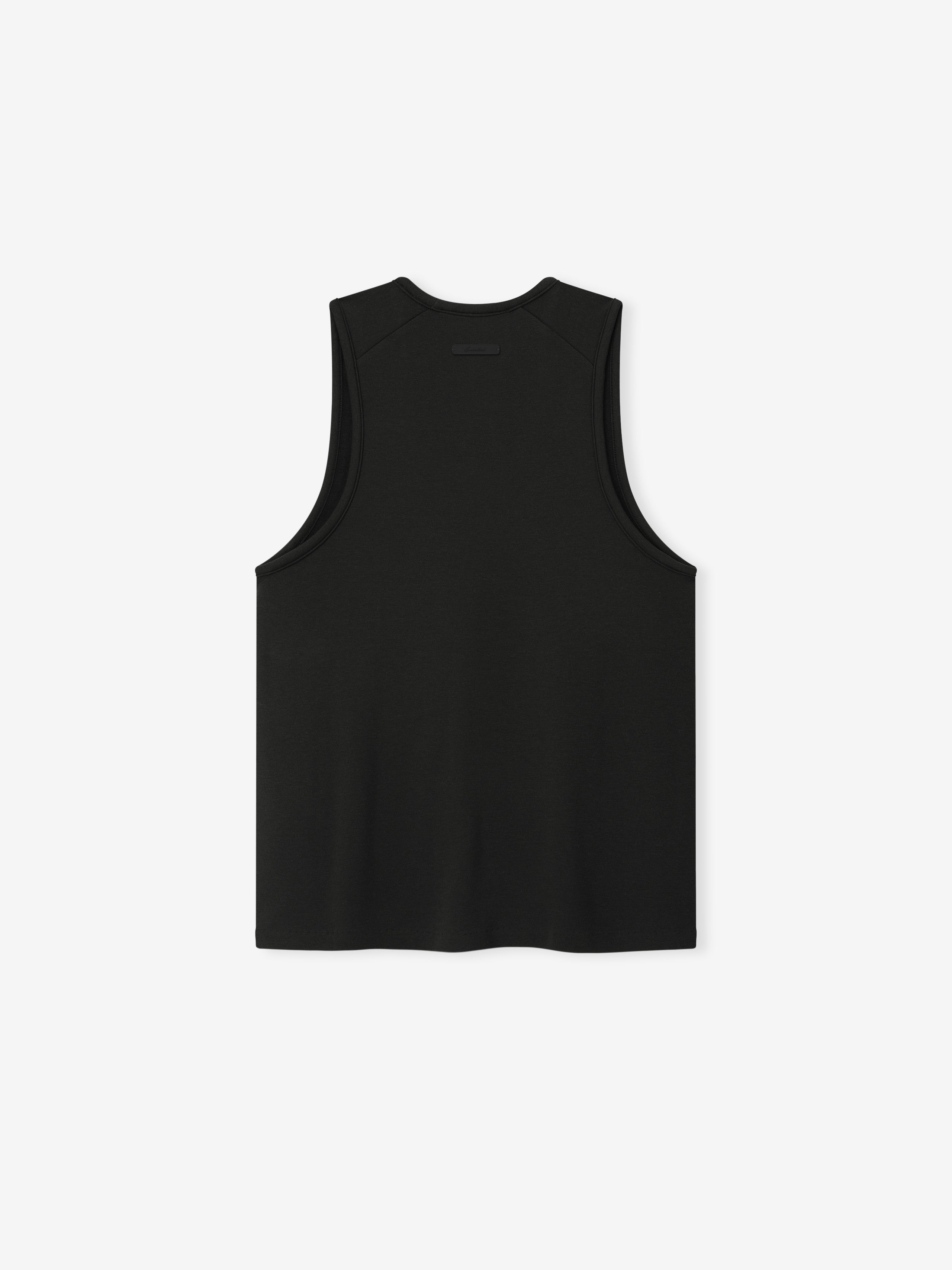 back view of women's black brushed jersey tank with relaxed fit, dropped armholes, and signature Essentials label at collar