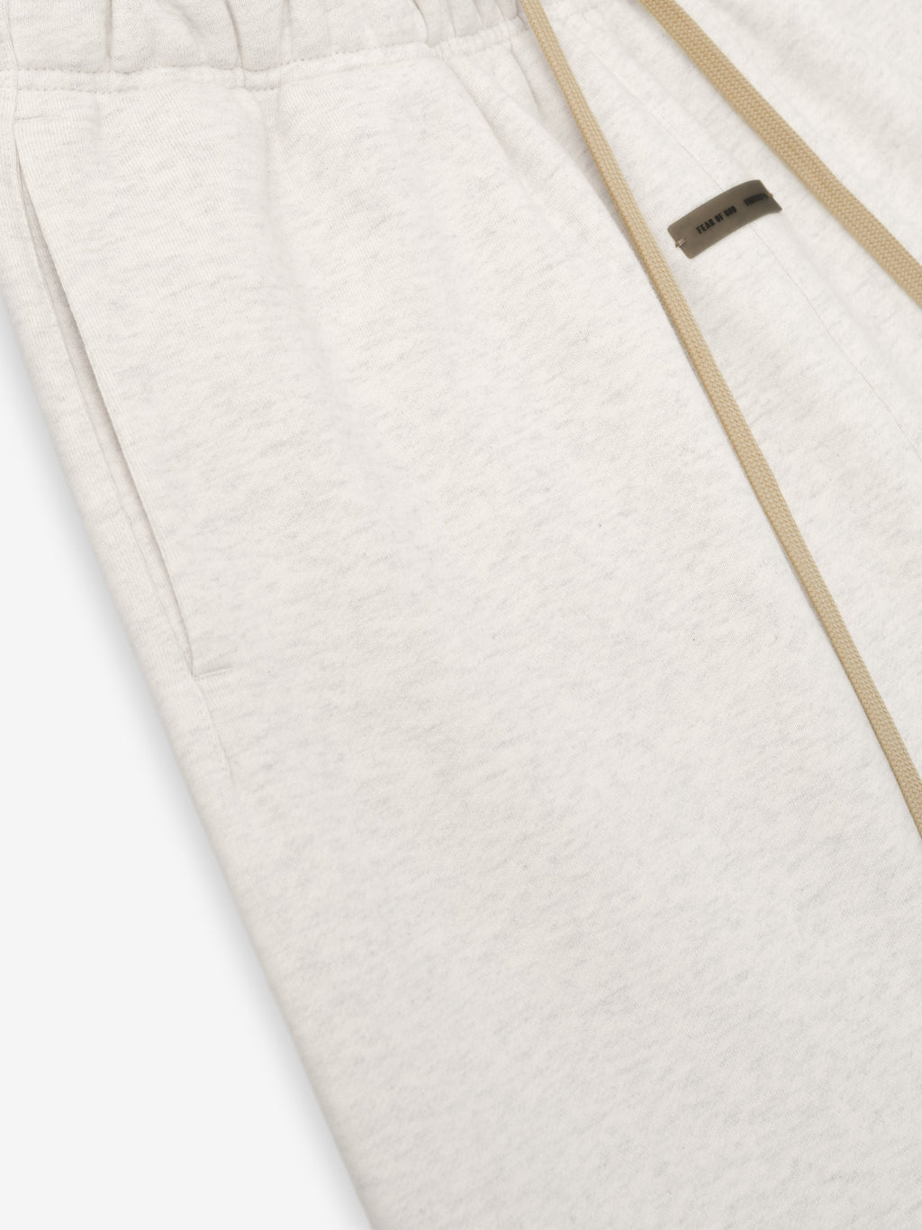 Close-up of oatmeal heather Womens Classic Sweatpant showing elastic waistband, side pocket, and beige drawstring detail.