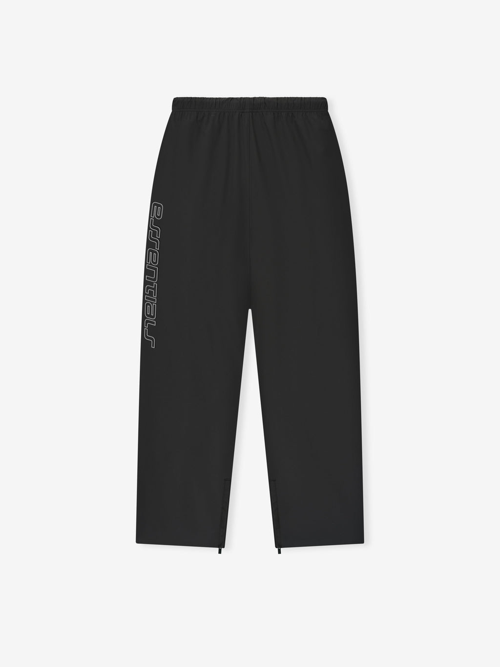 Flat lay of vintage black Tech Nylon Relaxed Track Pant showing elastic waistband and side reflective Essentials text detail