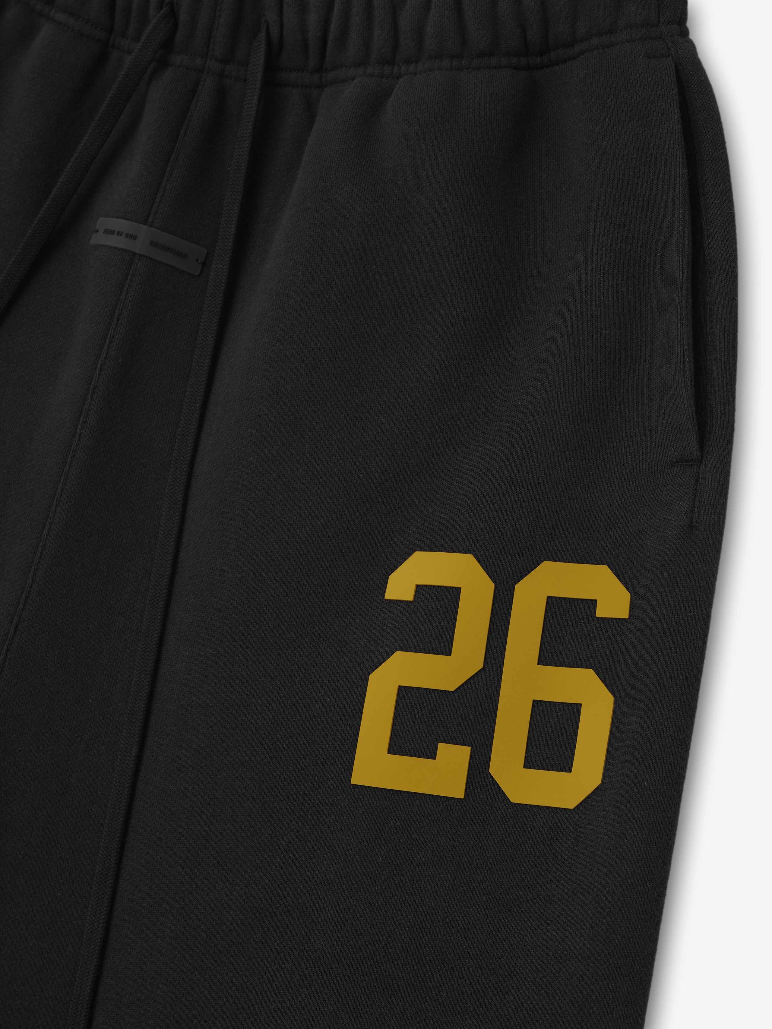 Close-up of vintage black Lounge Sweatpant featuring yellow "26" print and elastic waistband, gallery image 0