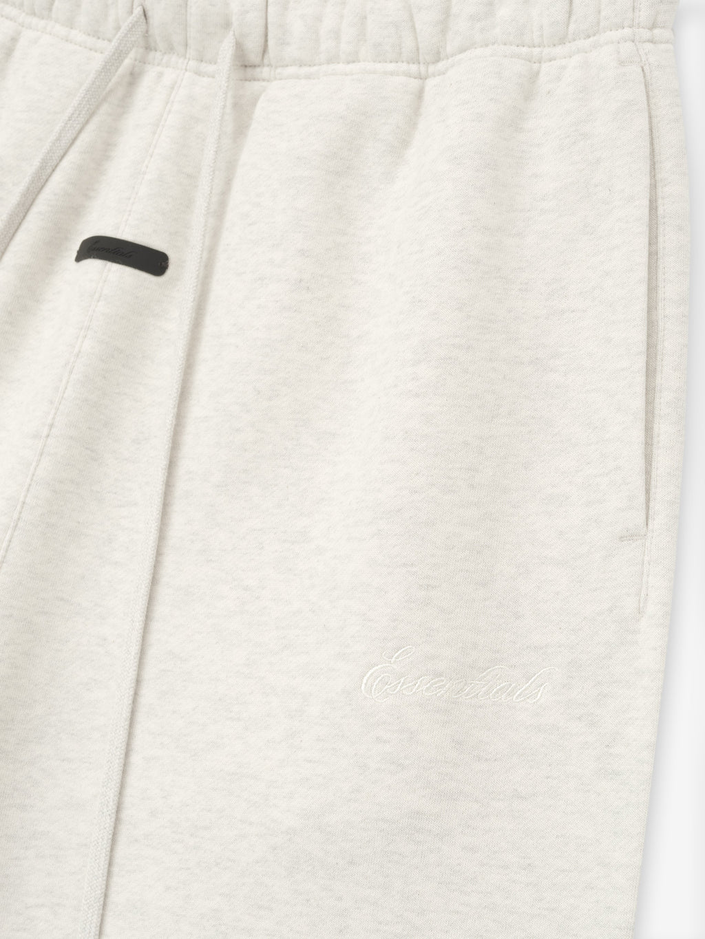 Close-up of a white garment with a black label on a white background