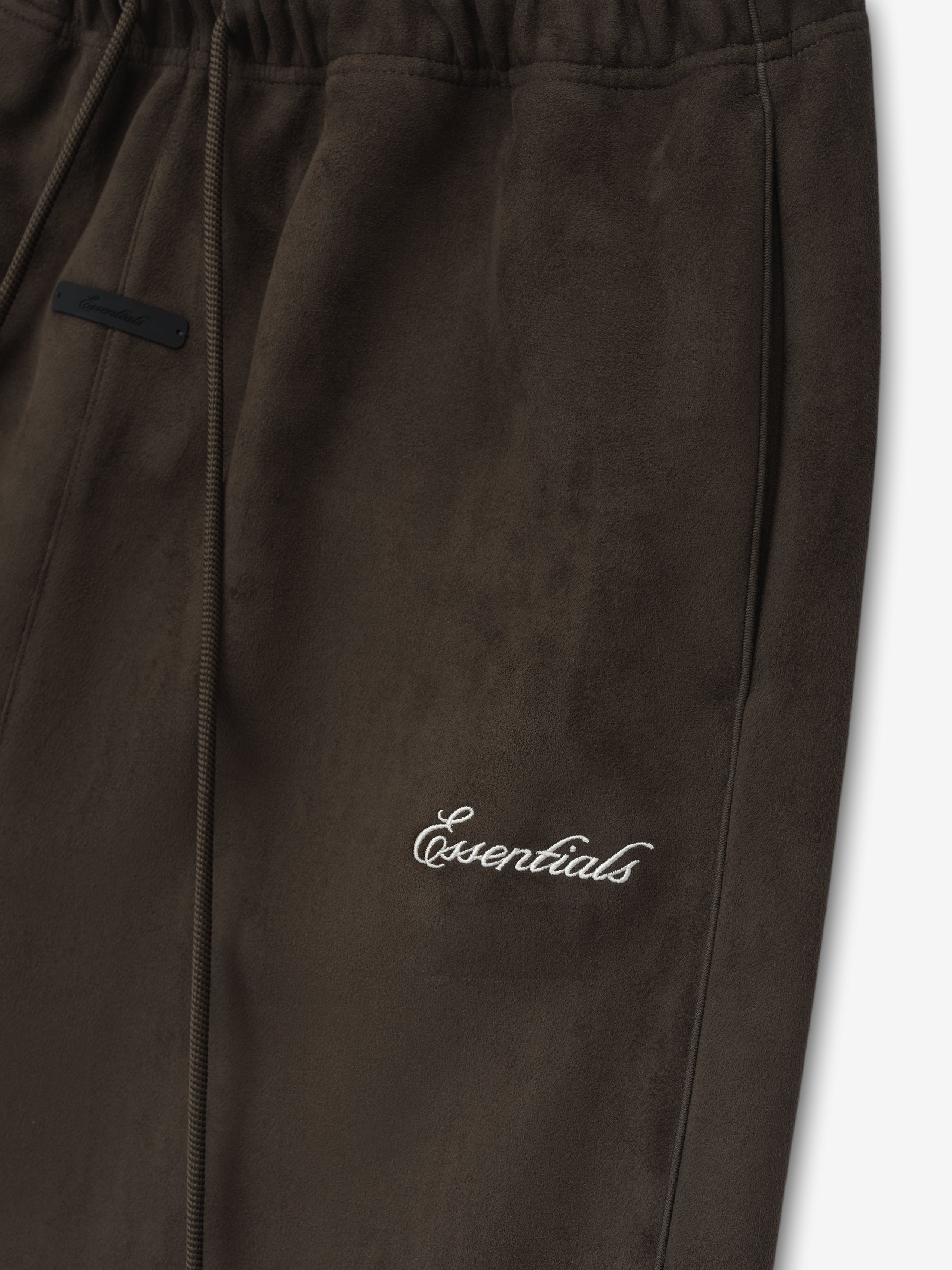 Brown pants with 'essentials' embroidery on a white background