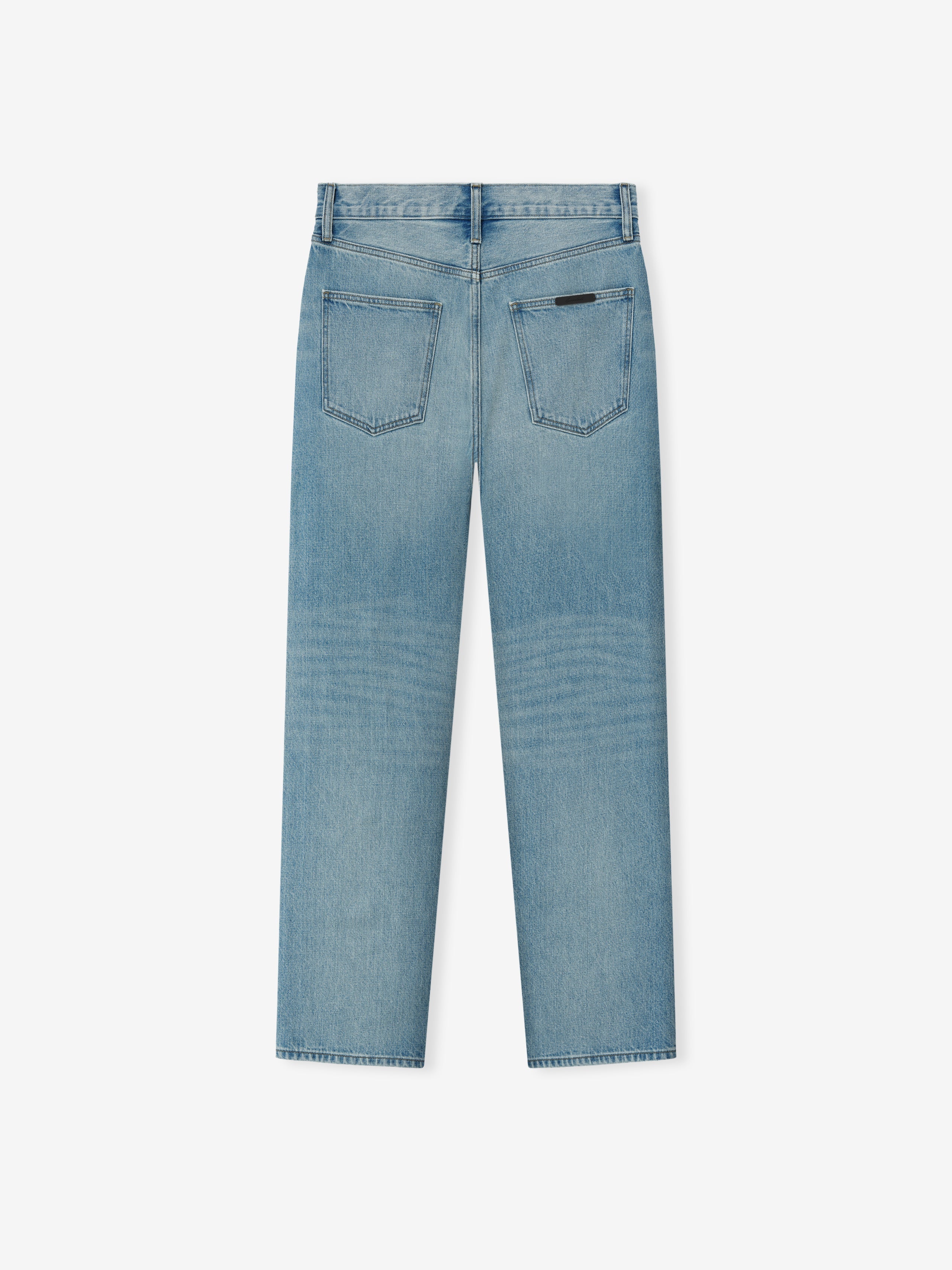 light blue straight leg denim jeans with vintage wash and two back patch pockets featuring a subtle label detail