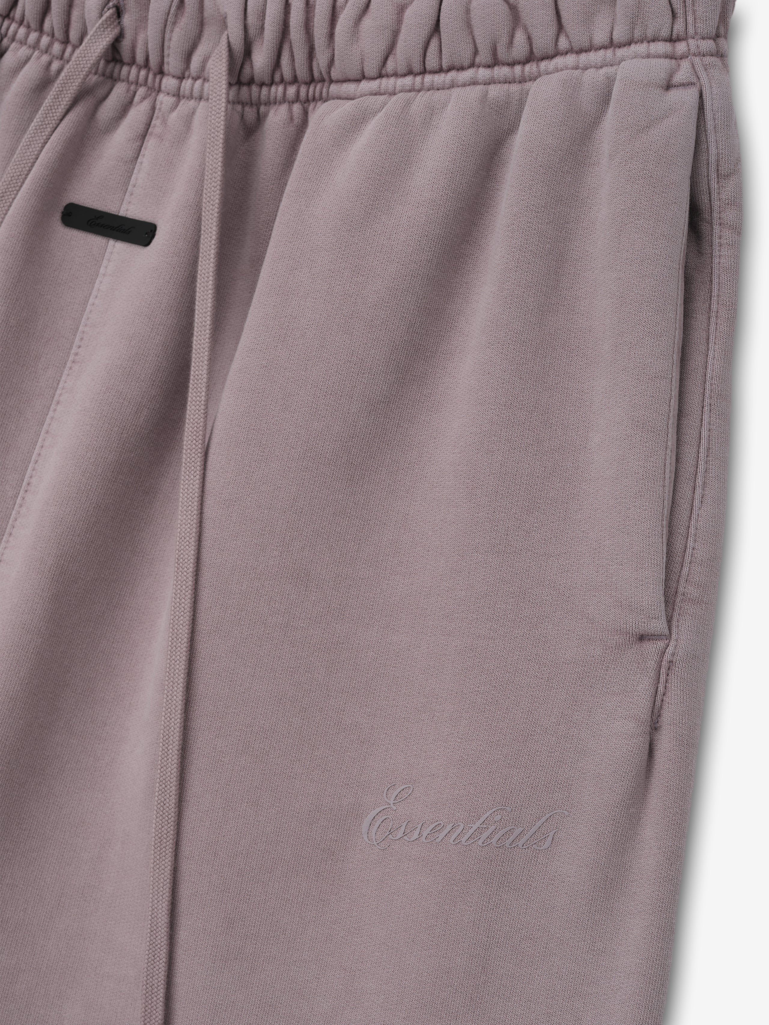 Womens Signature Classic Flare Sweatpant in a muted mauve shade featuring an elastic waistband with drawstrings, side pockets, and subtle tonal Essentials embroidery.