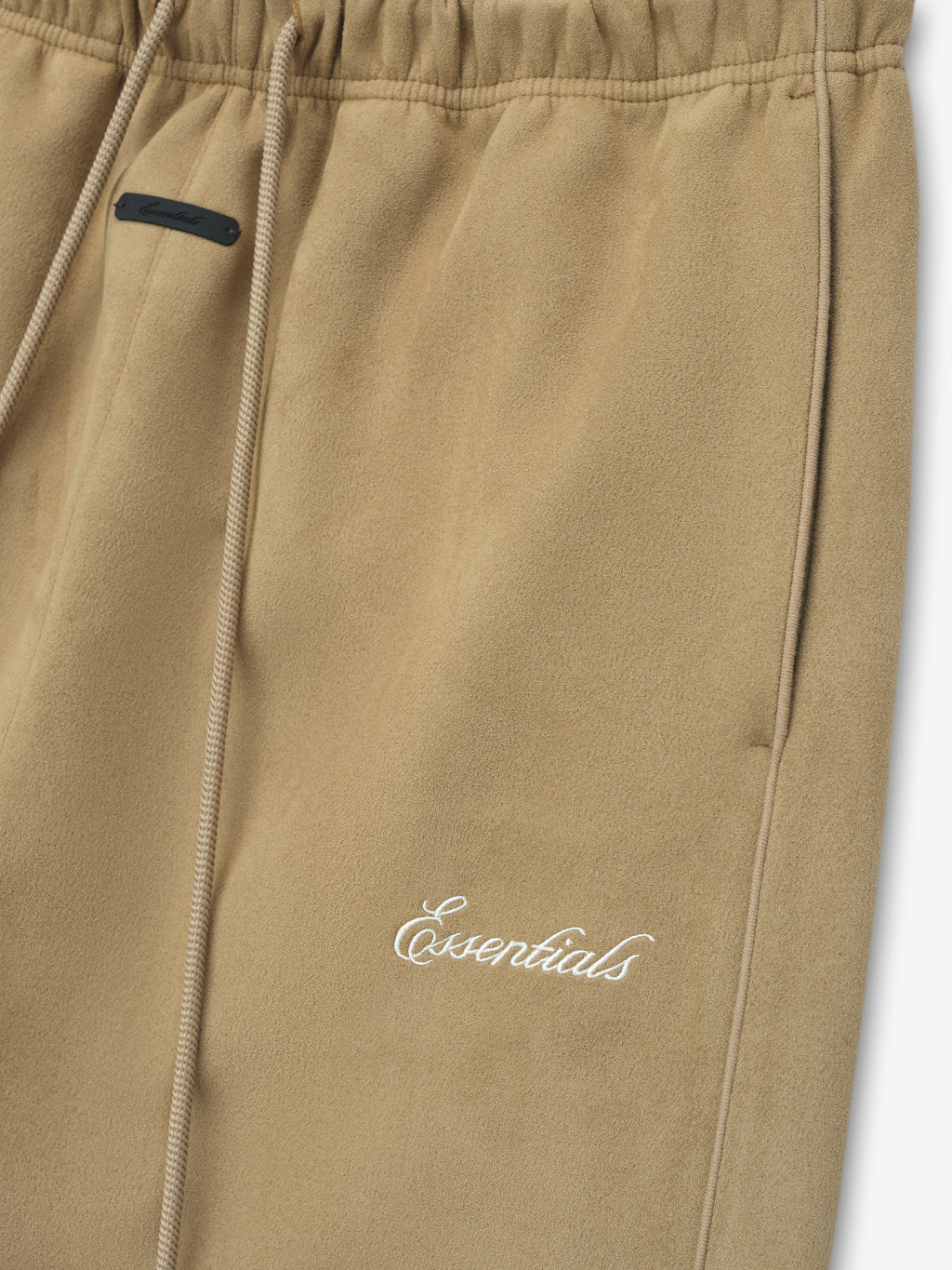 Beige pants with a brand logo on a white background