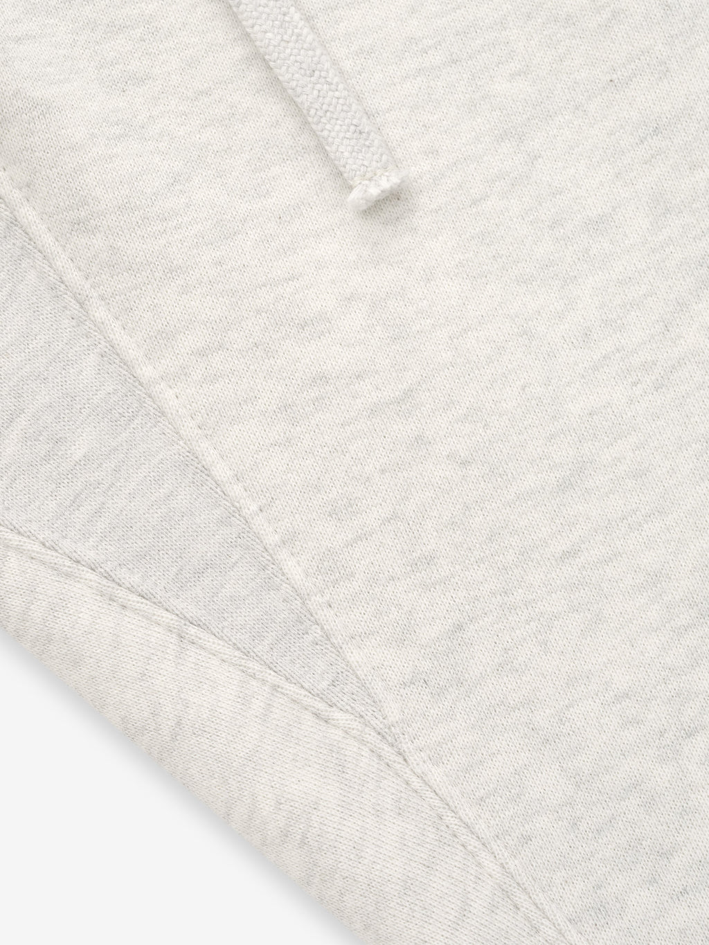 close-up of off-white core fleece fabric and stitching detail on relaxed fit sweatpants with drawstring waistband