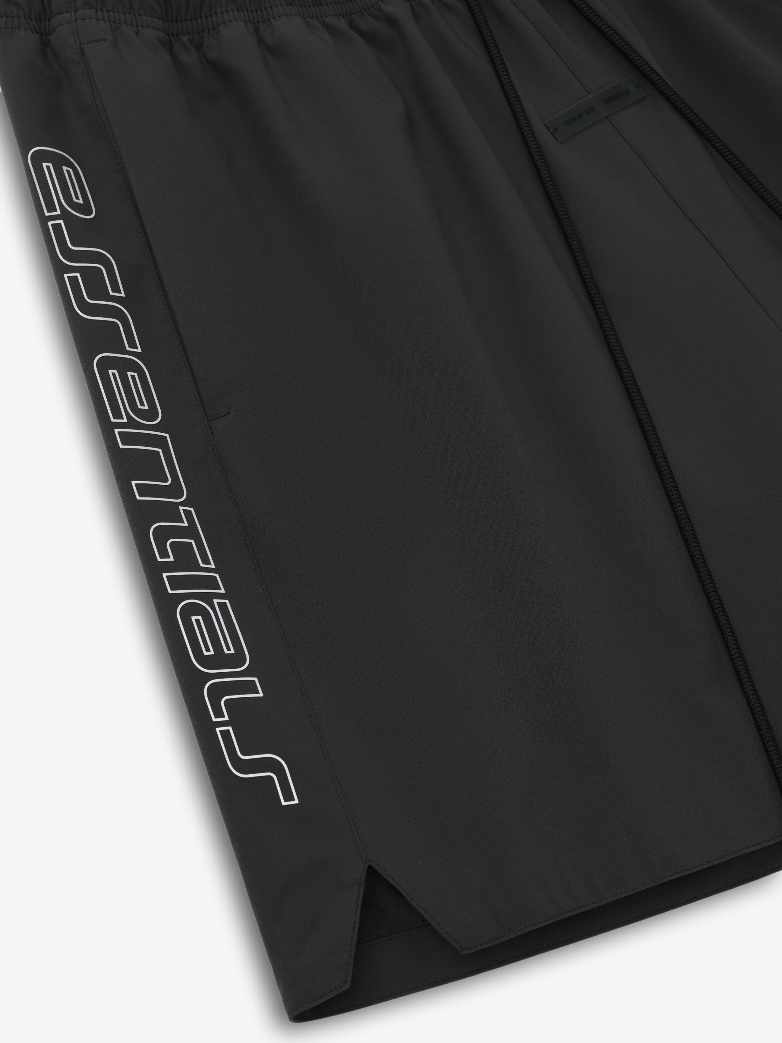 Close-up of vintage black Tech Nylon Classic Short showing tonal "essential" print on side and split hem detail