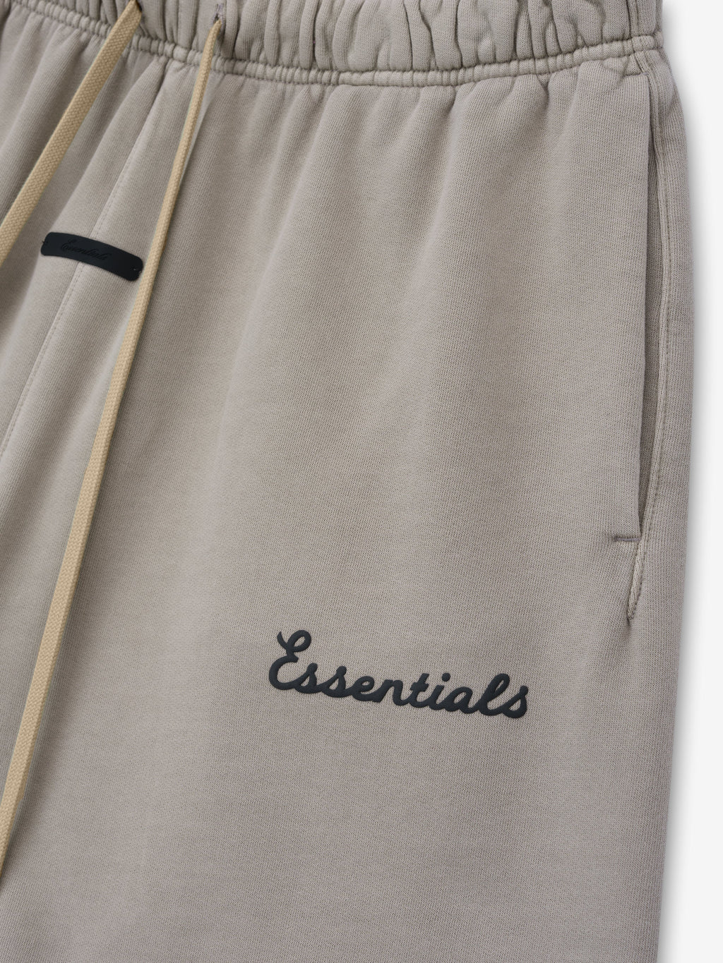 Grey shorts with 'essentials' script puff print logo on leg