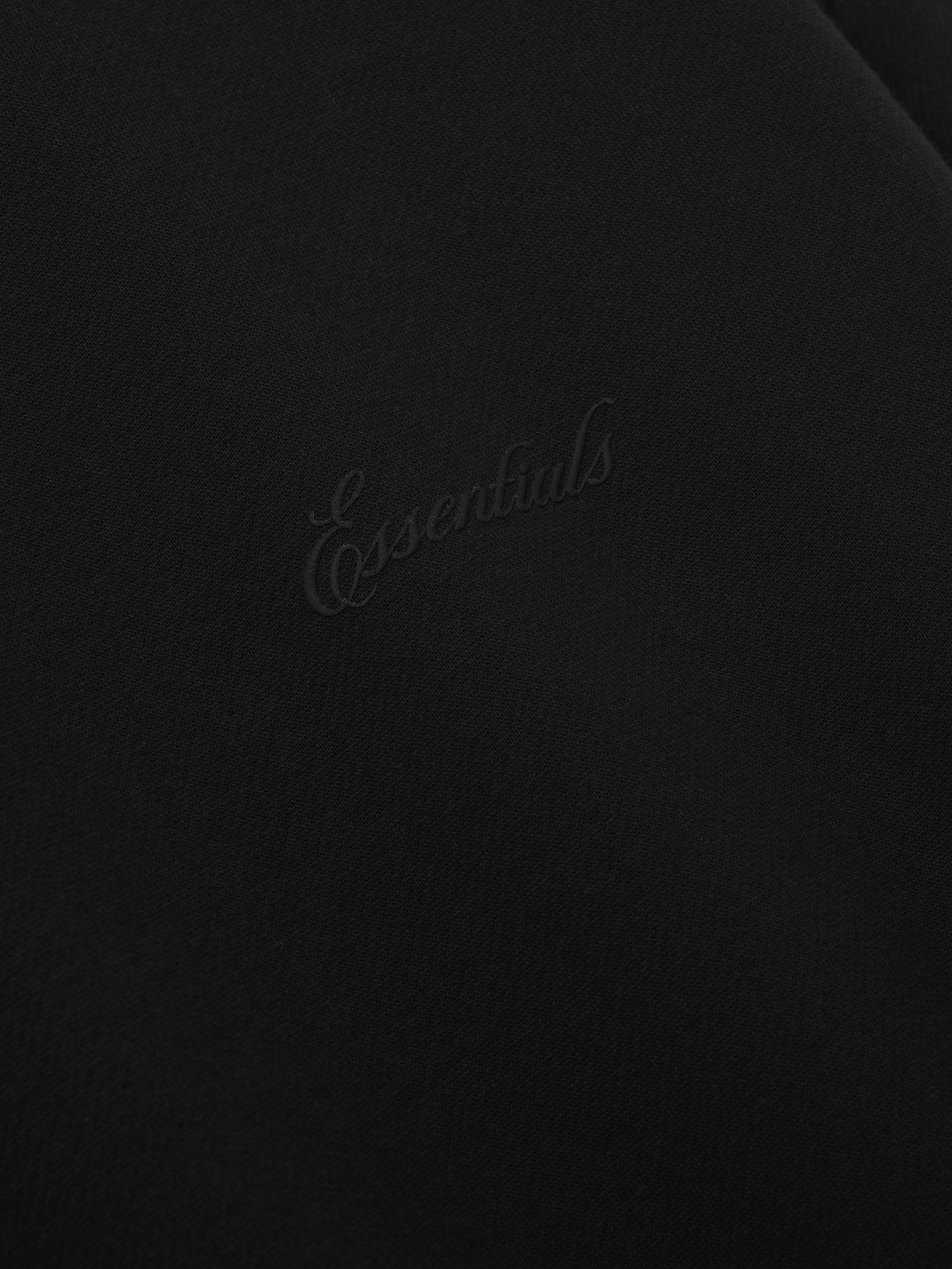 Black sweater with 'Essentials' signature logo