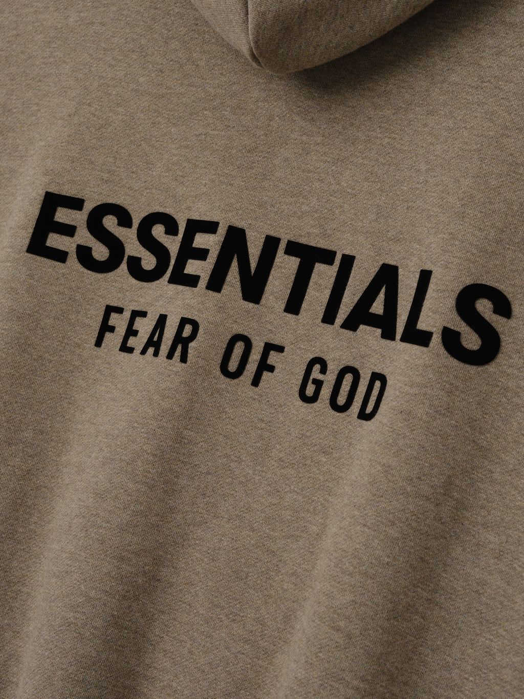 close-up of taupe heavy fleece fabric with black Essentials Fear of God logo printed on back of hoodie