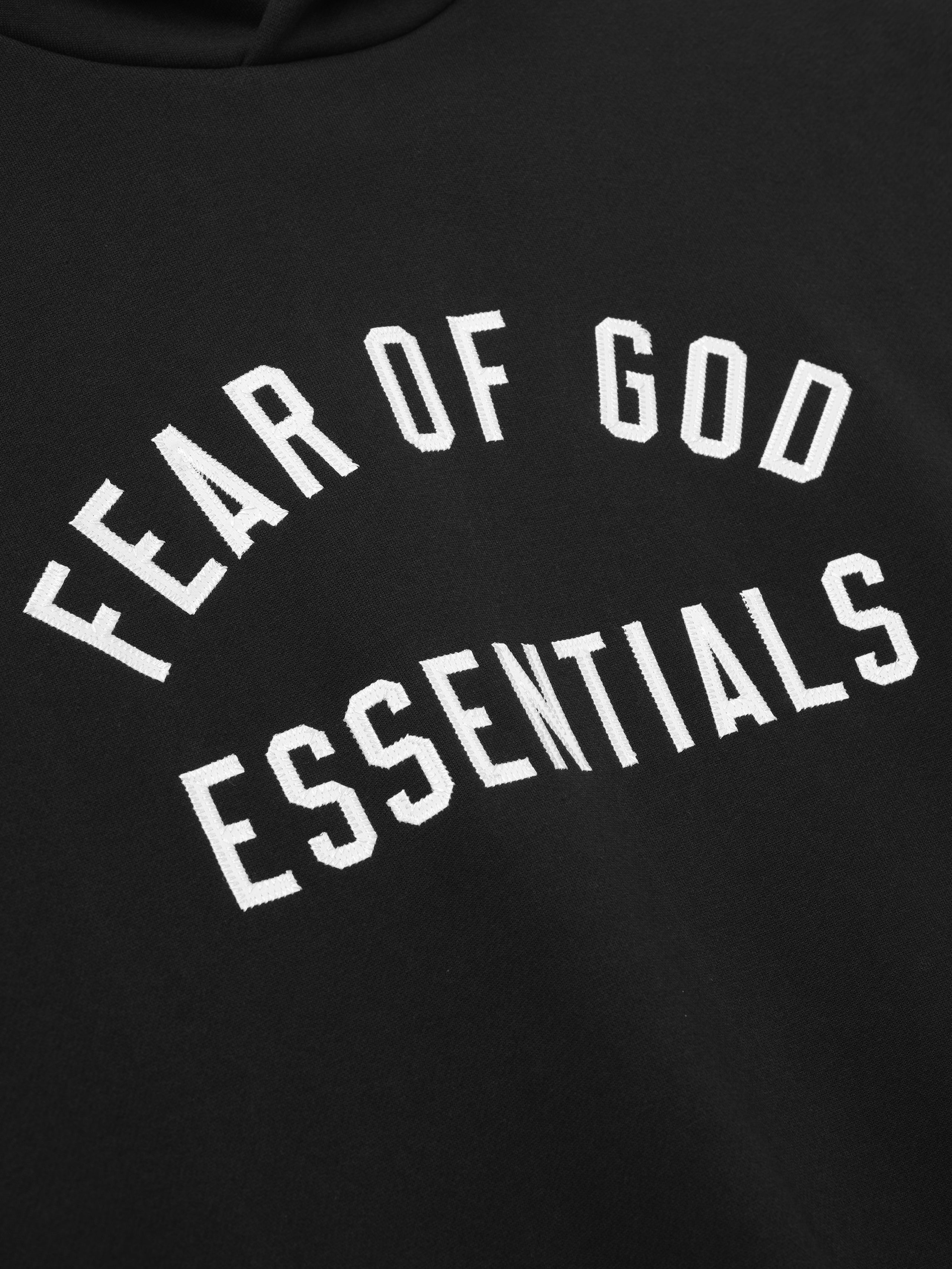 Black hoodie with 'Fear of God Essentials' text in white on a black background