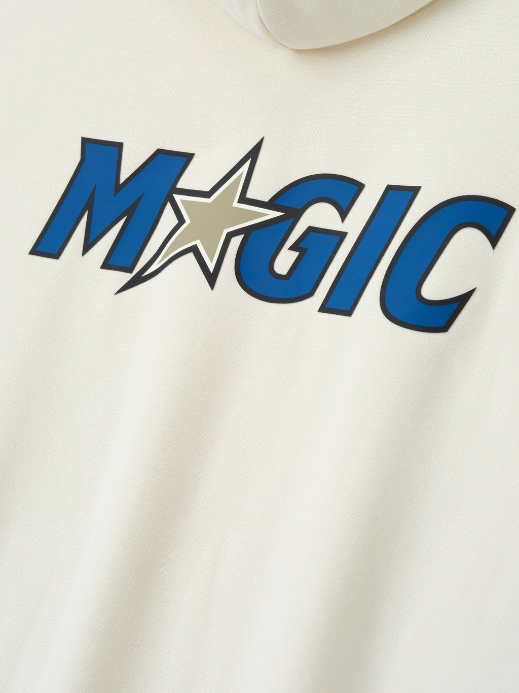Close-up of cream-colored Orlando Magic 90s Hoodie with bold blue and tan star graphic, gallery position 0.