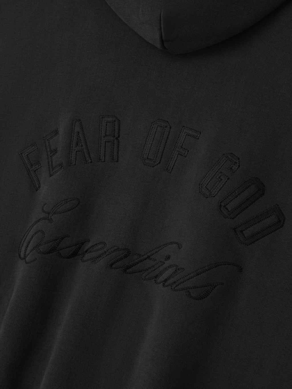 Close-up of vintage black Embroidered Classic Full Zip Hoodie showing tonal Fear of God Essentials logo embroidery on chest
