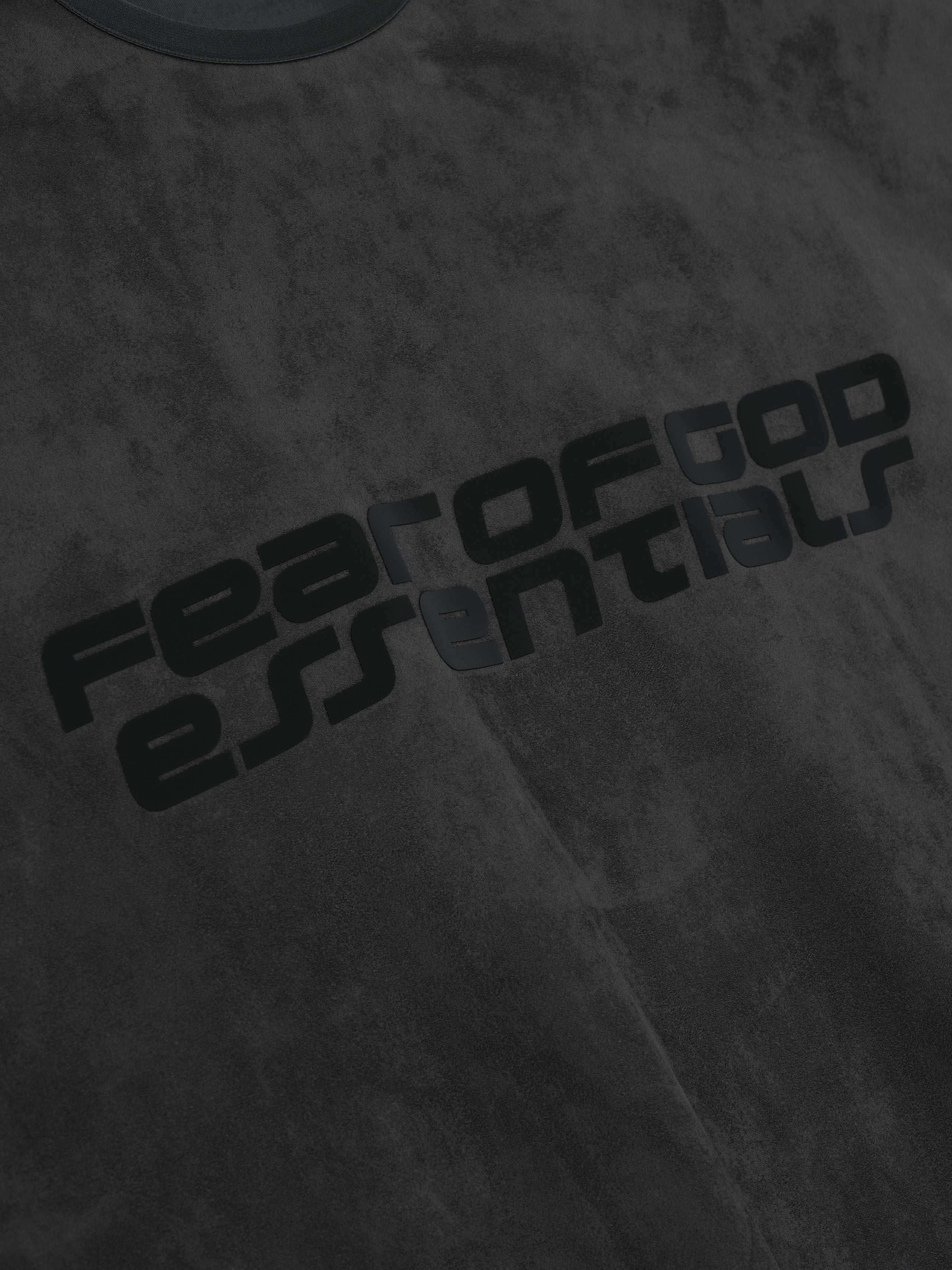 Close-up of iron grey Suede Fleece Modern Crewneck showing black Fear of God Essentials text print gallery 0
