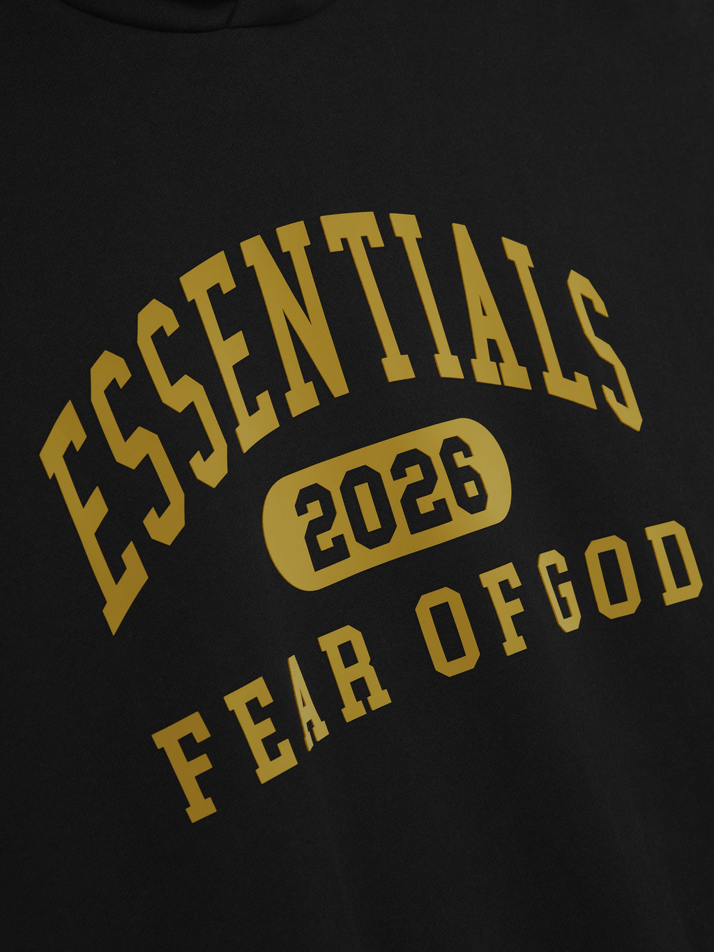 Close-up view of vintage black Classic Fleece Hoodie showing large yellow Essentials 2026 Fear of God text print