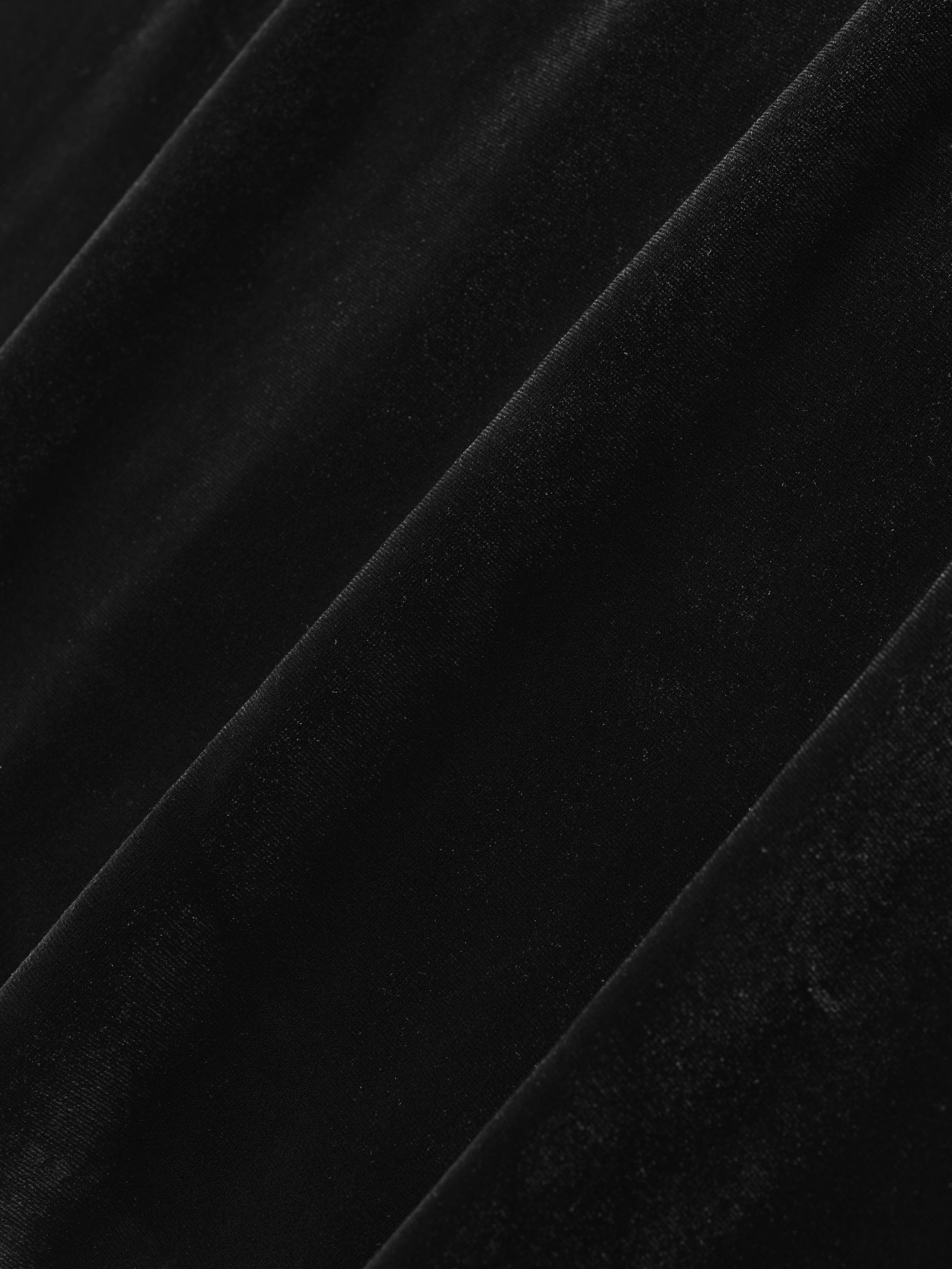 close-up of black high shine velour fabric with soft plush texture and subtle diagonal folds