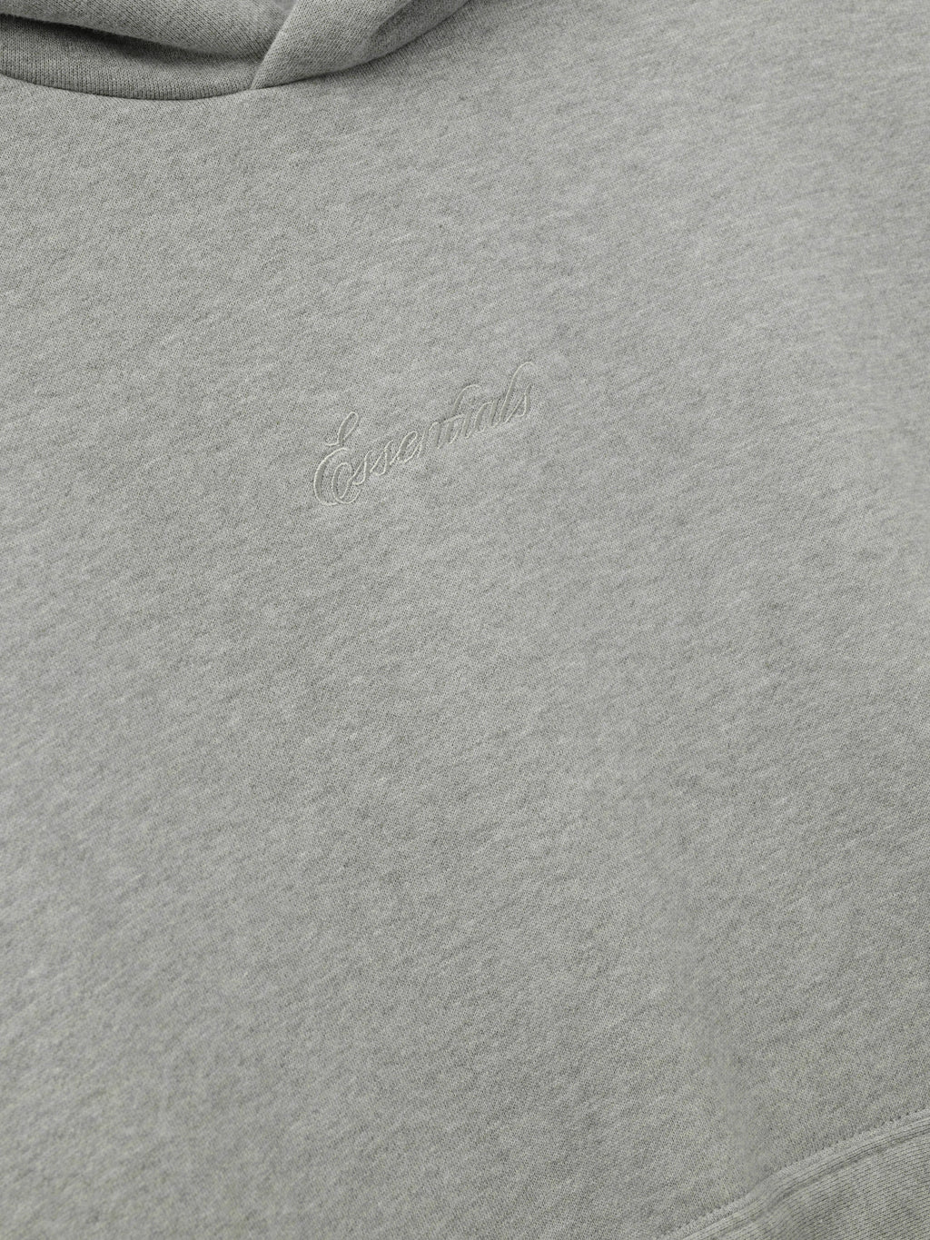 Gray hoodie with essentials embroidery on a white background