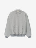 light gray 90s-inspired polo sweatshirt with relaxed fit, covered Henley placket, kangaroo pocket, and ribbed cuffs and hem