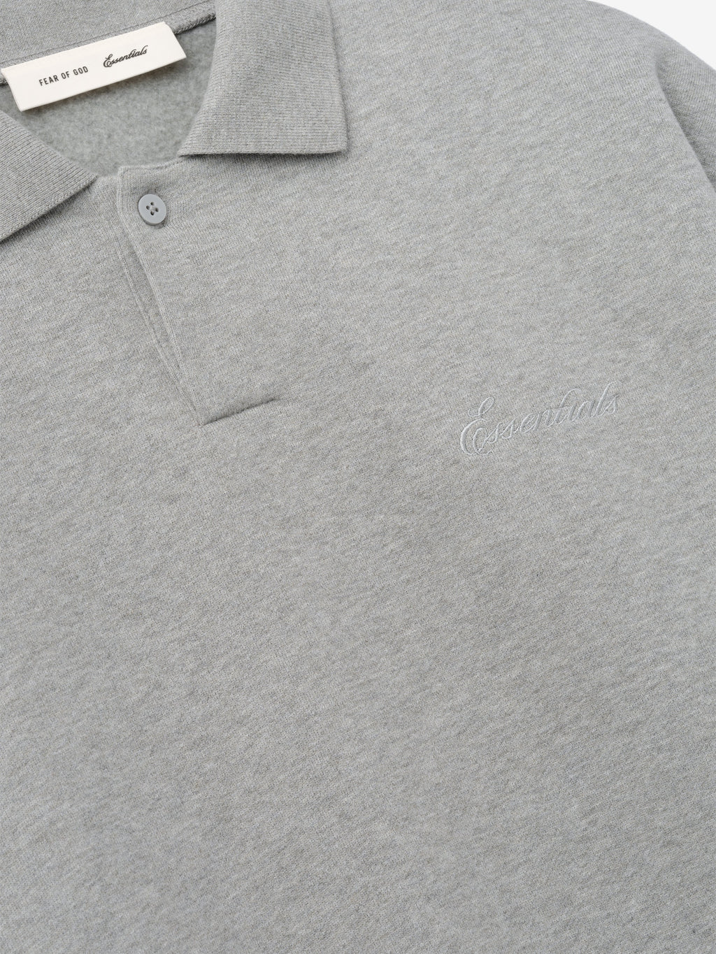 light gray 90s-inspired polo sweatshirt with covered Henley placket and subtle embroidered Essentials logo on chest