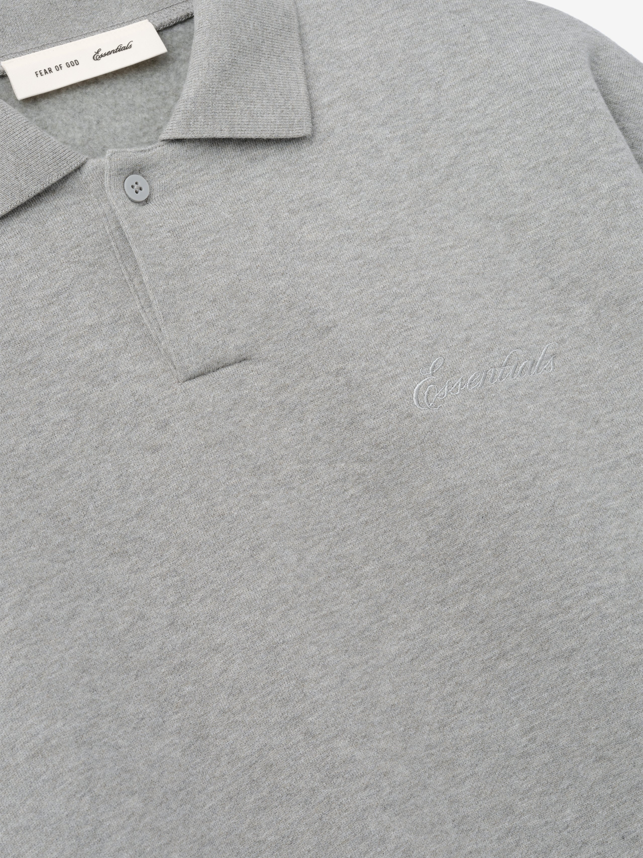 light gray 90s-inspired polo sweatshirt with covered Henley placket and subtle embroidered Essentials logo on chest
