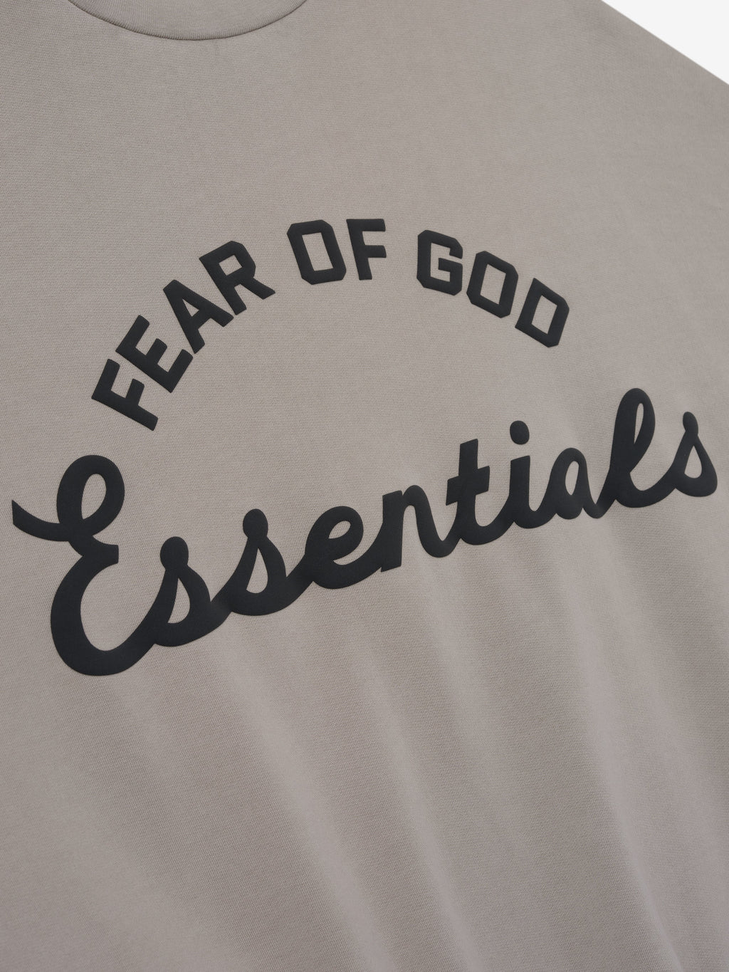Gray sweatshirt with 'Fear of God Essentials' text on a plain background