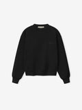 front view of womens relaxed fit black crewneck sweatshirt with ribbed cuffs and hem on heavyweight fleece