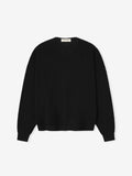 Black sweater on a light gray background