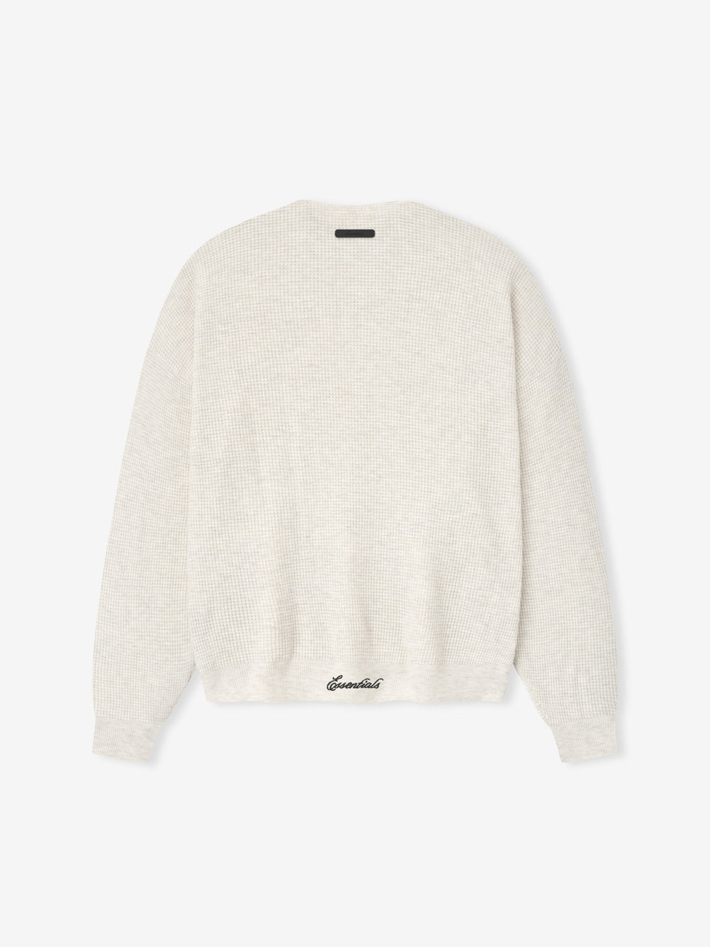 White sweater with 'Essential' branding on a white background