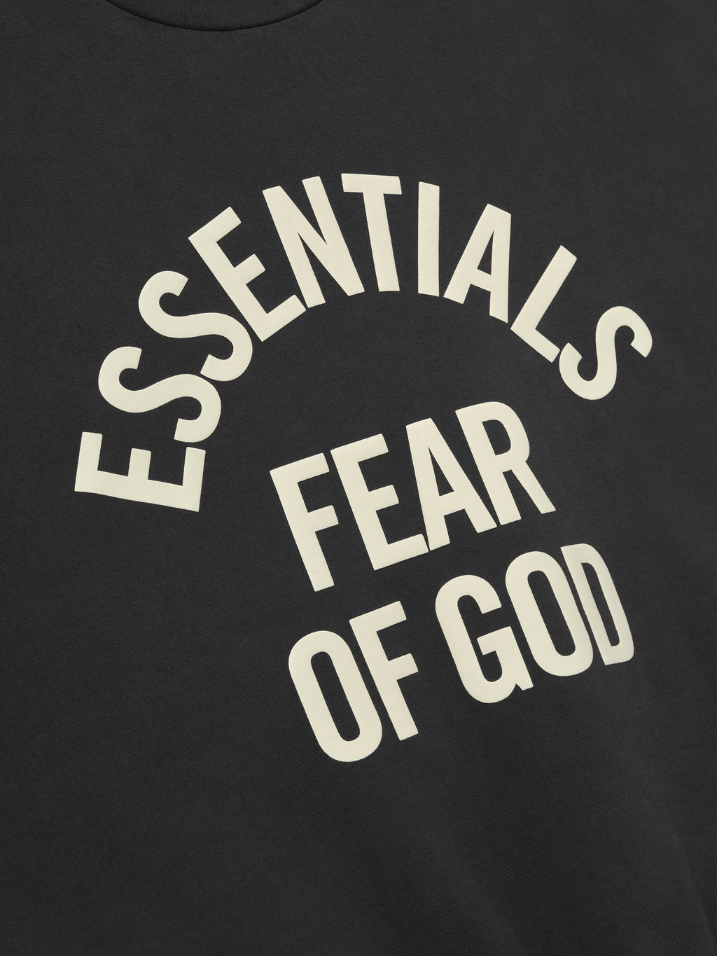 close-up of black vintage-style cropped crewneck sweatshirt with large cream Essentials Fear of God printed logo
